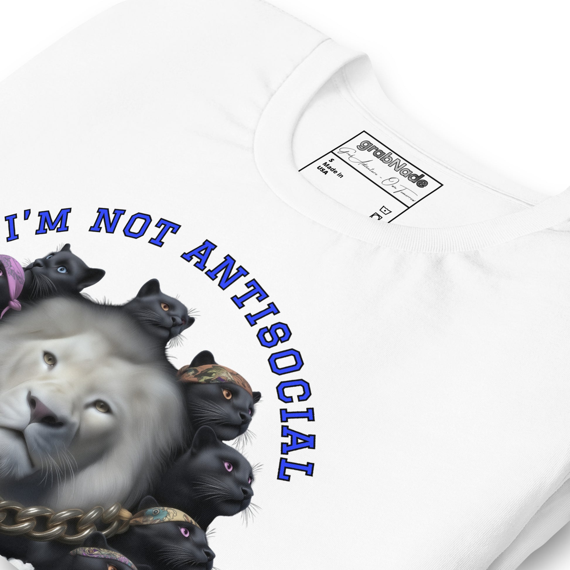 Product mockup. Close-up of a white T-shirt showing a realistic white lion and a group of black cats wearing bandanas, above the phrase “I’M NOT ANTISOCIAL”.