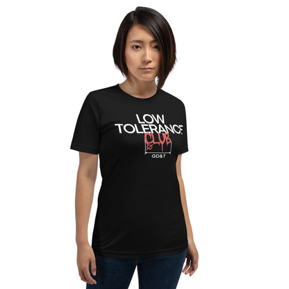 Woman in black t-shirt with "LOW TOLERANCE CLUB" dripping precision tolerance numbers graphic.