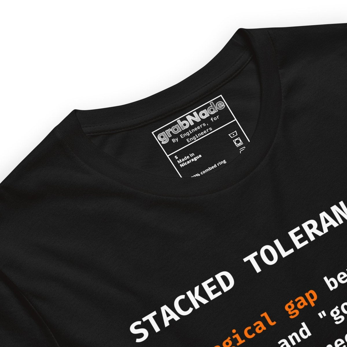 Close  up of black t-shirt with "Stacked Tolerances magical gap perfect good enough" engineering definition.