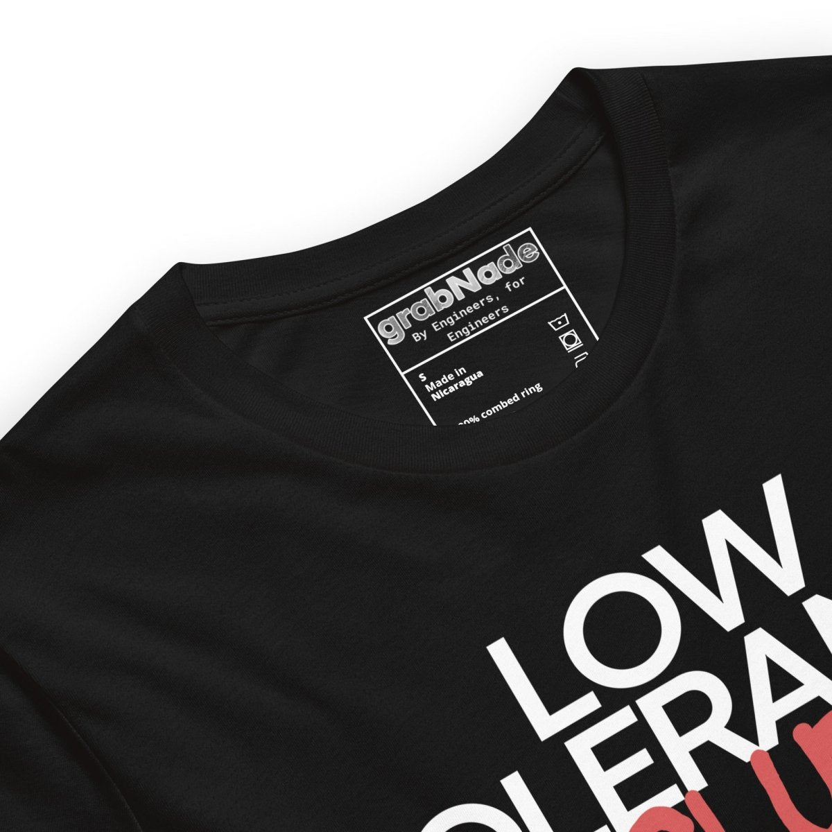Close up of black t-shirt with "LOW TOLERANCE CLUB" dripping precision tolerance numbers graphic.