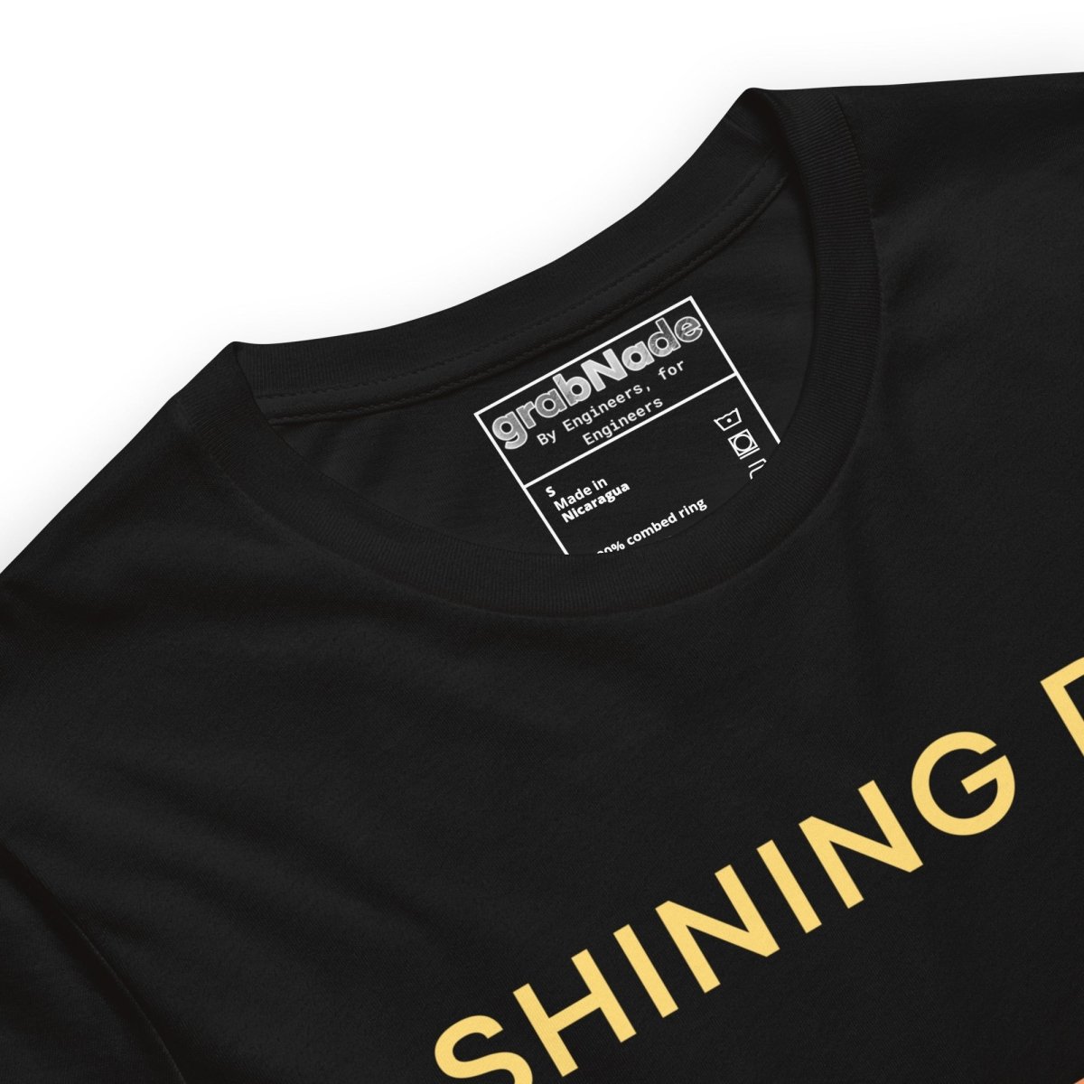 Close up of black tee featuring an Ra0.02 surface finish symbol on a geometric sunset horizon line.
