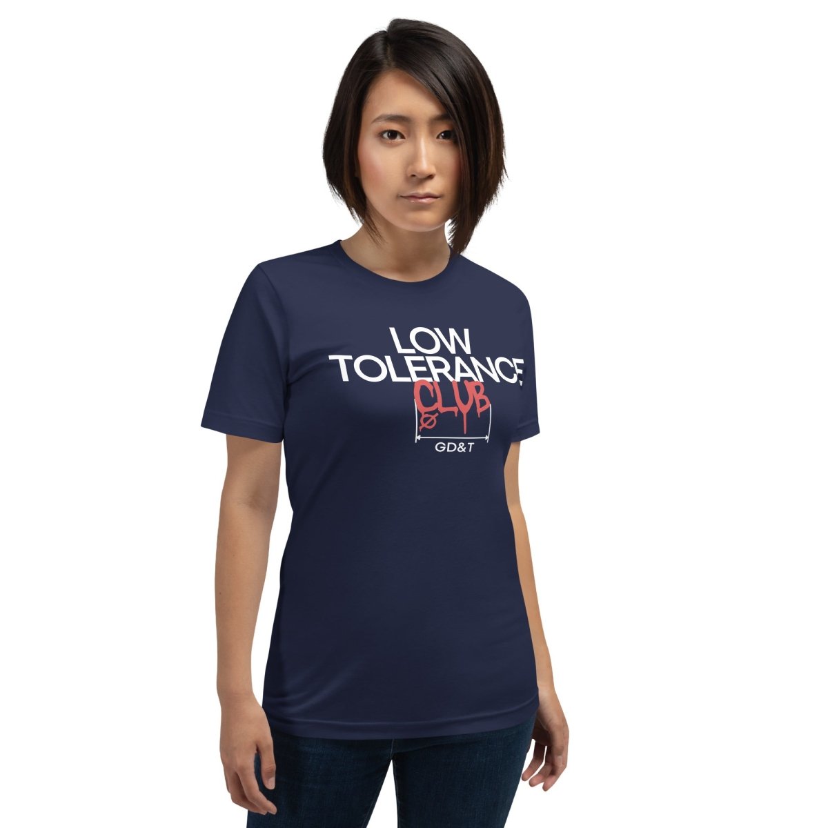 Woman in navy t-shirt with "LOW TOLERANCE CLUB" dripping precision tolerance numbers graphic.