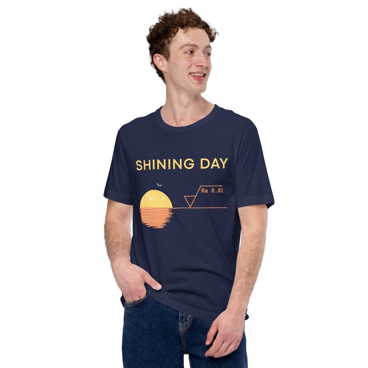 Man in navy t-shirt featuring an Ra0.02 surface finish symbol on a geometric sunset horizon line.
