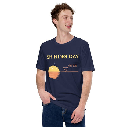 Man in navy t-shirt featuring an Ra0.02 surface finish symbol on a geometric sunset horizon line.