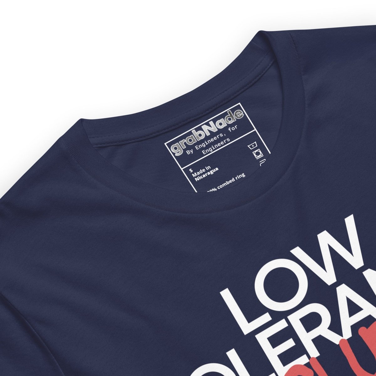 Close up of navy t-shirt with "LOW TOLERANCE CLUB" dripping precision tolerance numbers graphic.