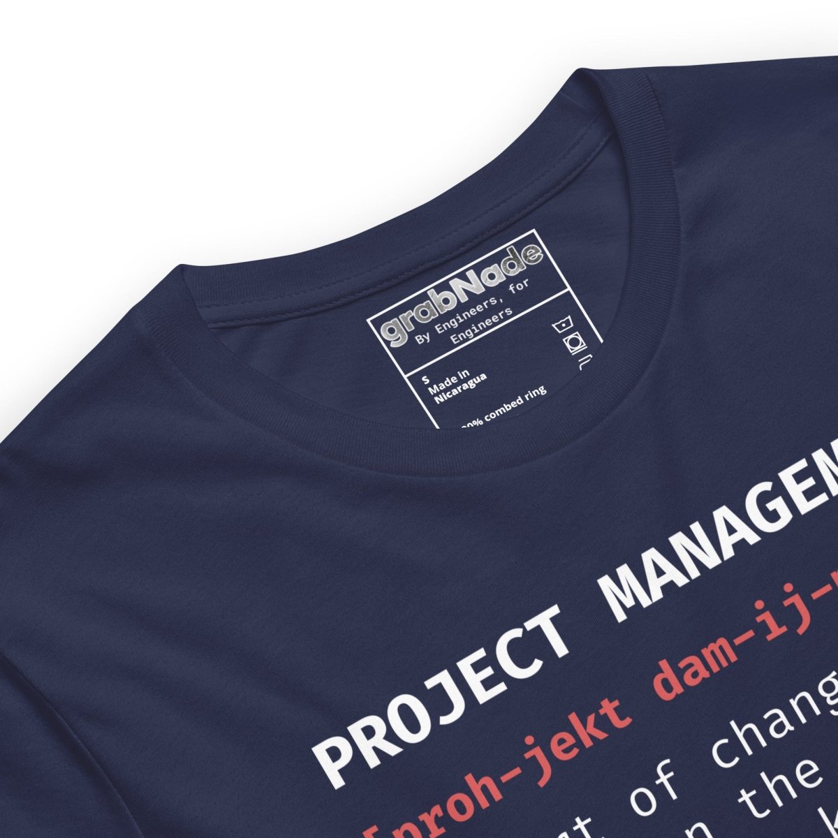 Close up of navy t-shirt "Project Management [proh-jekt dam-ij-ment] ctrl+alt+pray" definition.