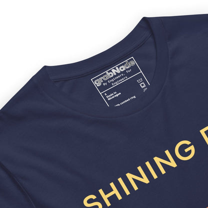 Close up of navy tee featuring an Ra0.02 surface finish symbol on a geometric sunset horizon line.