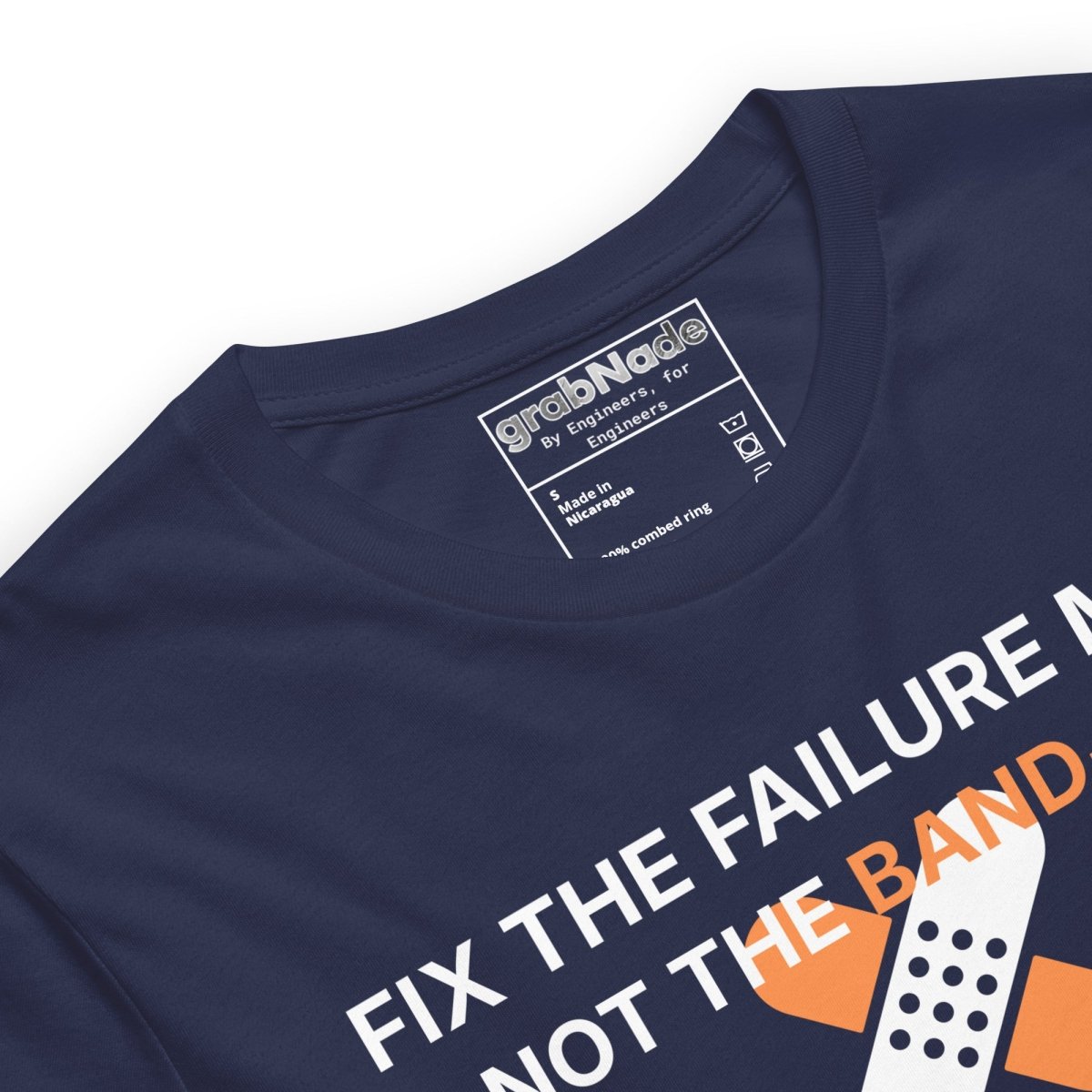 Close up of navy t-shirt with "Fix the failure mode. Not the band-aids" text. For engineers & tech.