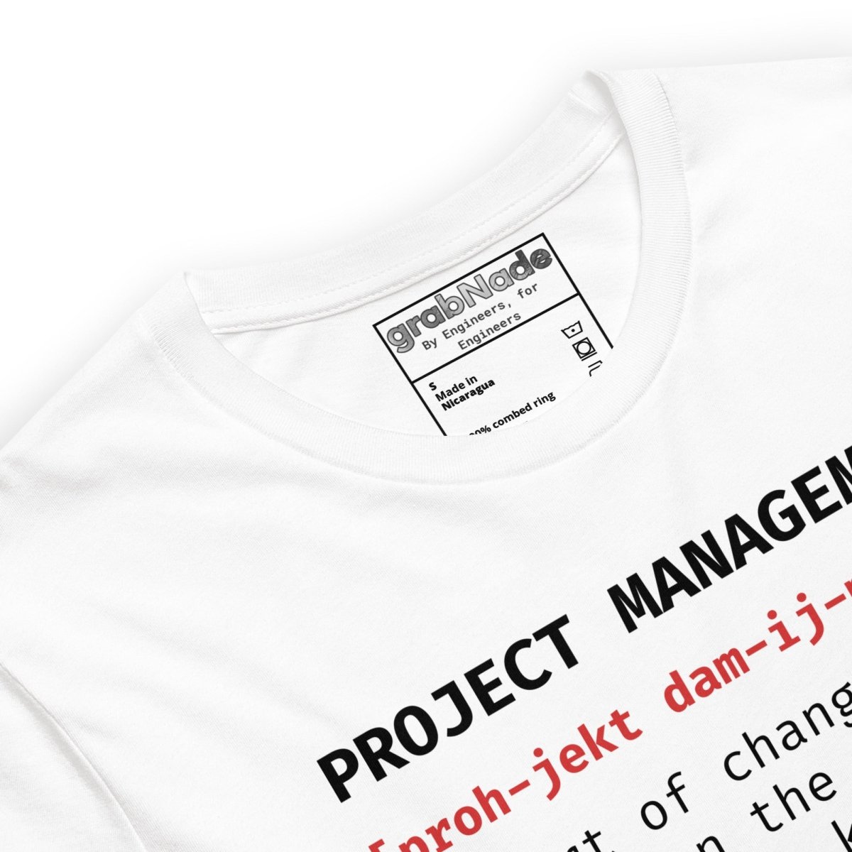 Close up of white t-shirt "Project Management [proh-jekt dam-ij-ment] ctrl+alt+pray" definition.