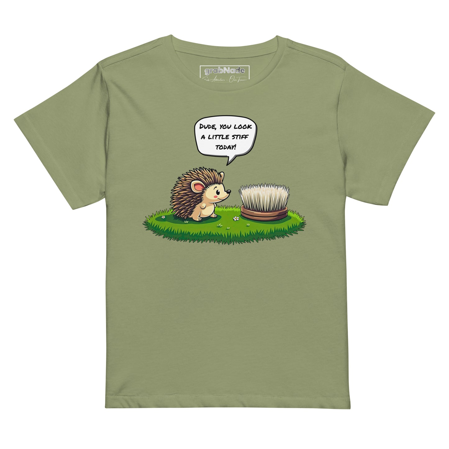 Product mockup. Light green high-waisted women's t-shirt laid flat against a plain background. A colorful cartoon graphic of a hedgehog with a speech bubble—'Dude, you look a little stiff today!'—faces a scrubbing brush on grass. The shirt label at the collar reads 'grabNade.