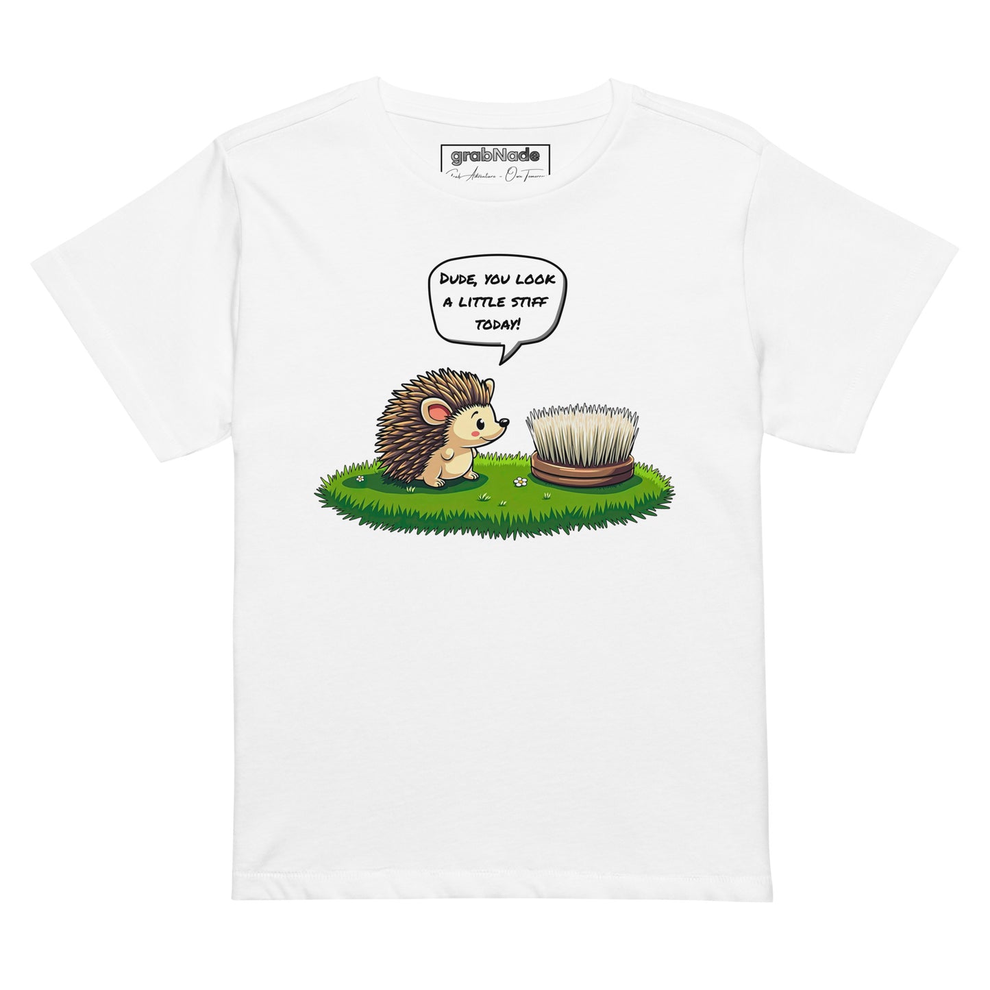 Product mockup. White high-waisted women's t-shirt laid flat against a plain background. A colorful cartoon graphic of a hedgehog with a speech bubble—'Dude, you look a little stiff today!'—faces a scrubbing brush on grass. The shirt label at the collar reads 'grabNade.