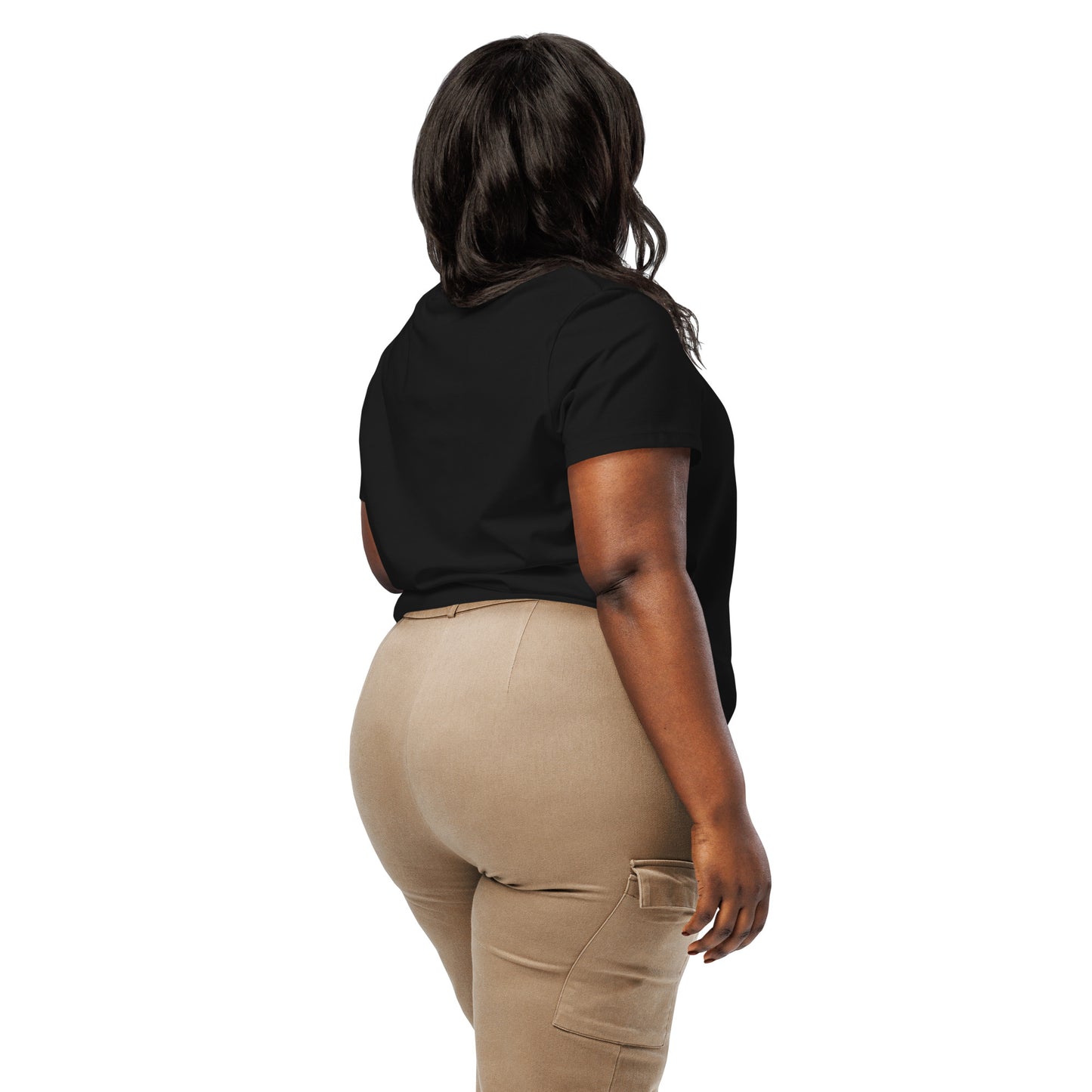 Product mockup. A woman shown from behind wearing a plain black organic cotton t-shirt with short sleeves. The shirt has a relaxed fit, and no design or graphics appear on the back. She is also wearing khaki pants with side pockets.