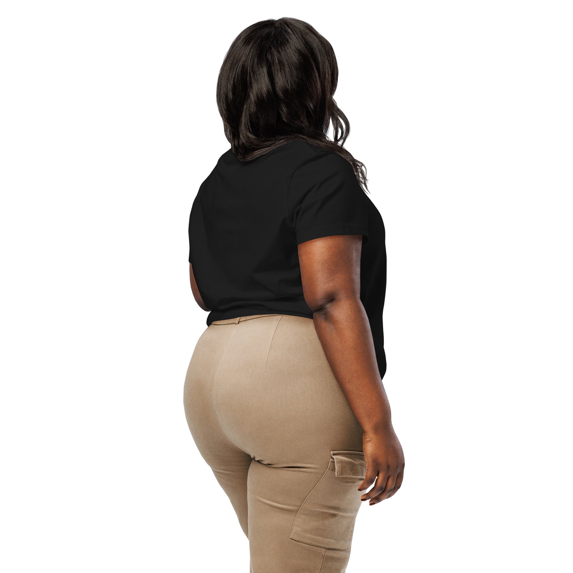Product mockup. A woman shown from behind wearing a plain black organic cotton t-shirt with short sleeves. The shirt has a relaxed fit, and no design or graphics appear on the back. She is also wearing khaki pants with side pockets.
