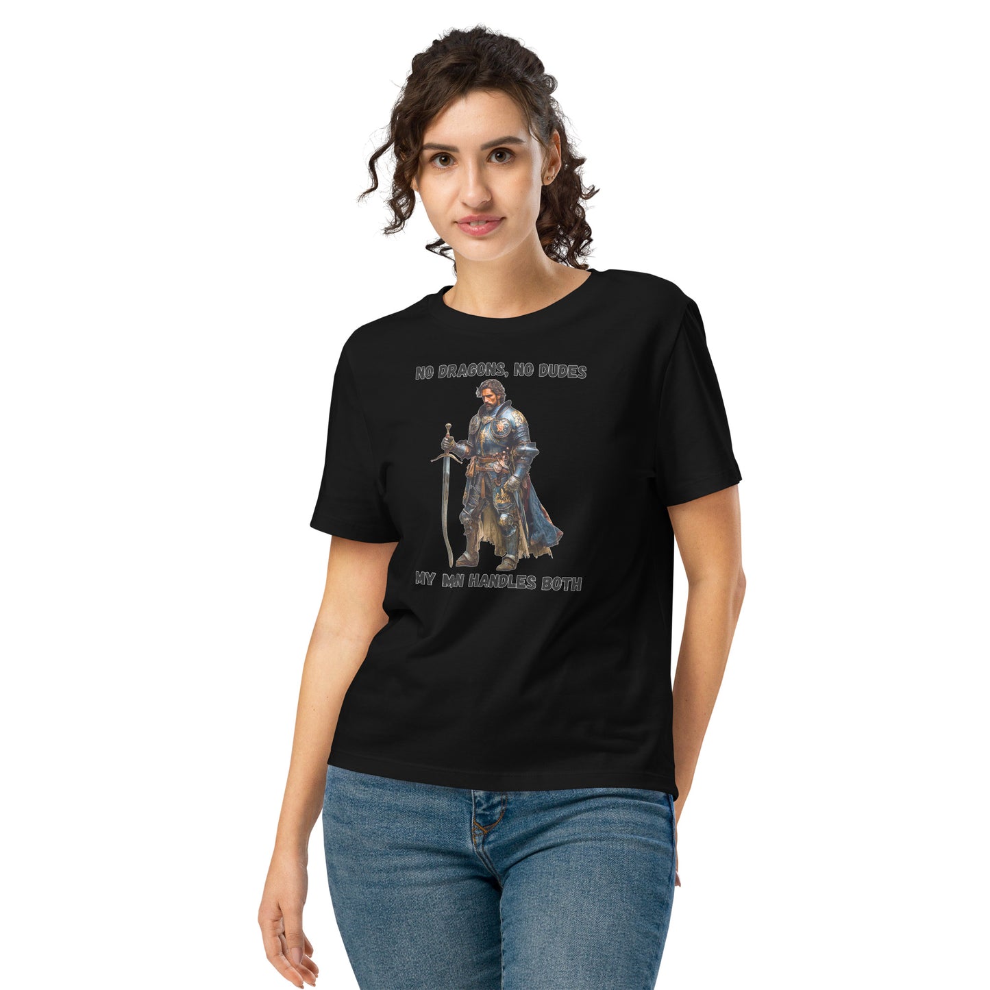 Product mockup. Organic premium black t-shirt featuring warrior knight in detailed armor holding sword with bold black text above and below stating 'NO DRAGONS, NO DUDES MY MAN HANDLES BOTH,' modeled on smiling woman.