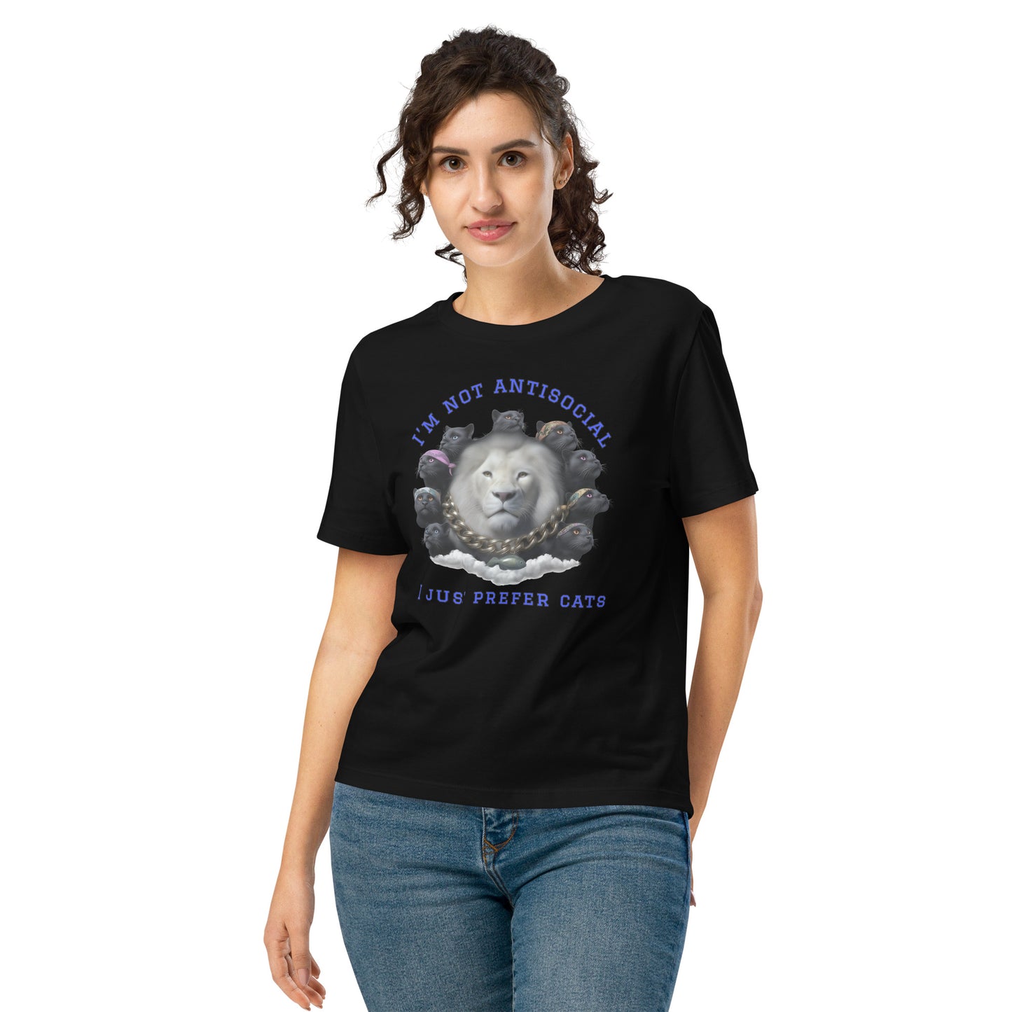 Product mockup. A woman wearing a black organic cotton t-shirt featuring a bold graphic on the front: a large white lion's head surrounded by black panthers wearing colorful bandanas, arranged in a circle. Above the graphic is the phrase 'I'M NOT ANTISOCIAL' and below it reads 'I JUST PREFER CATS' in blue capital letters.