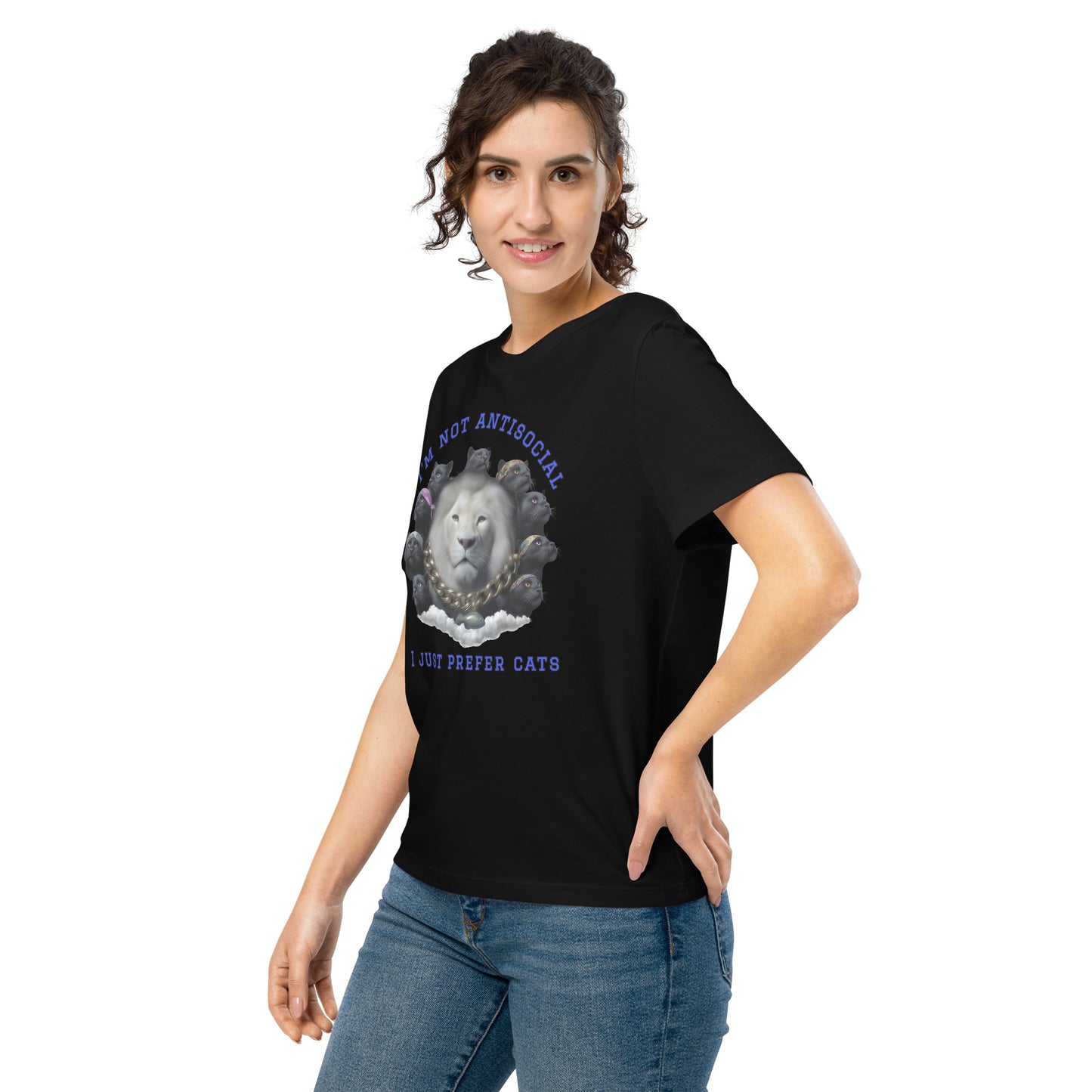 Product mockup. A woman wearing a black organic cotton t-shirt featuring a bold graphic on the front: a large white lion's head surrounded by black panthers wearing colorful bandanas, arranged in a circle. Above the graphic is the phrase 'I'M NOT ANTISOCIAL' and below it reads 'I JUST PREFER CATS' in blue capital letters.