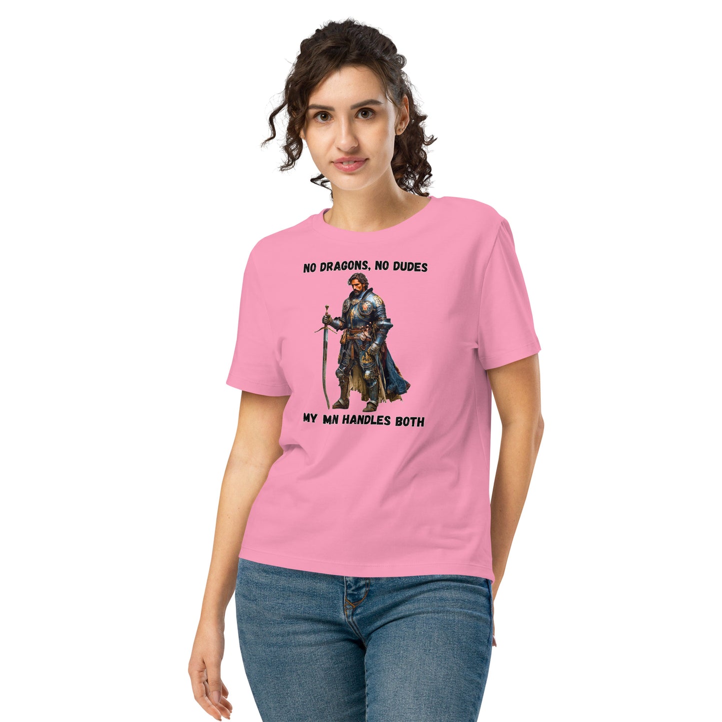 Product mockup. Organic premium pink t-shirt featuring warrior knight in detailed armor holding sword with bold black text above and below stating 'NO DRAGONS, NO DUDES MY MAN HANDLES BOTH,' modeled on smiling woman.