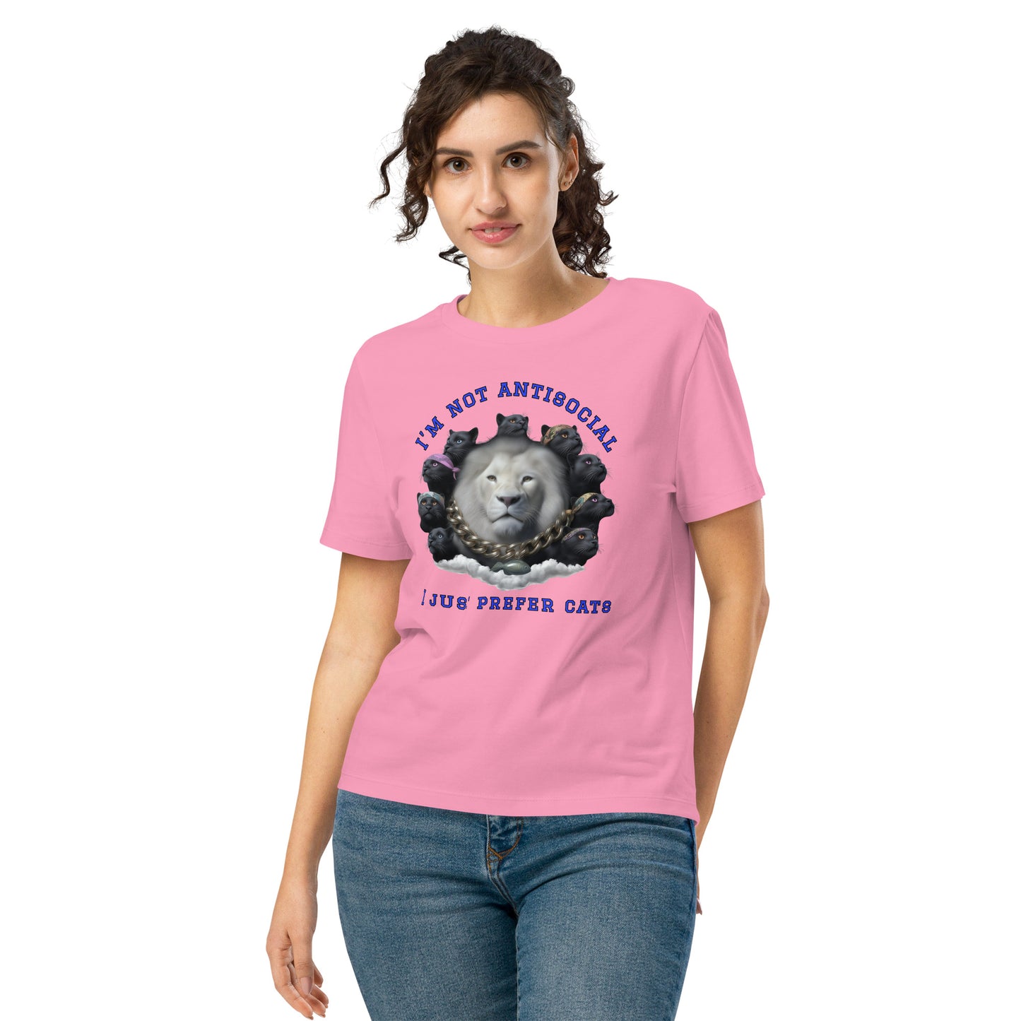 Product mockup. A woman wearing a pink organic cotton t-shirt featuring a bold graphic on the front: a large white lion's head surrounded by black panthers wearing colorful bandanas, arranged in a circle. Above the graphic is the phrase 'I'M NOT ANTISOCIAL' and below it reads 'I JUST PREFER CATS' in blue capital letters.