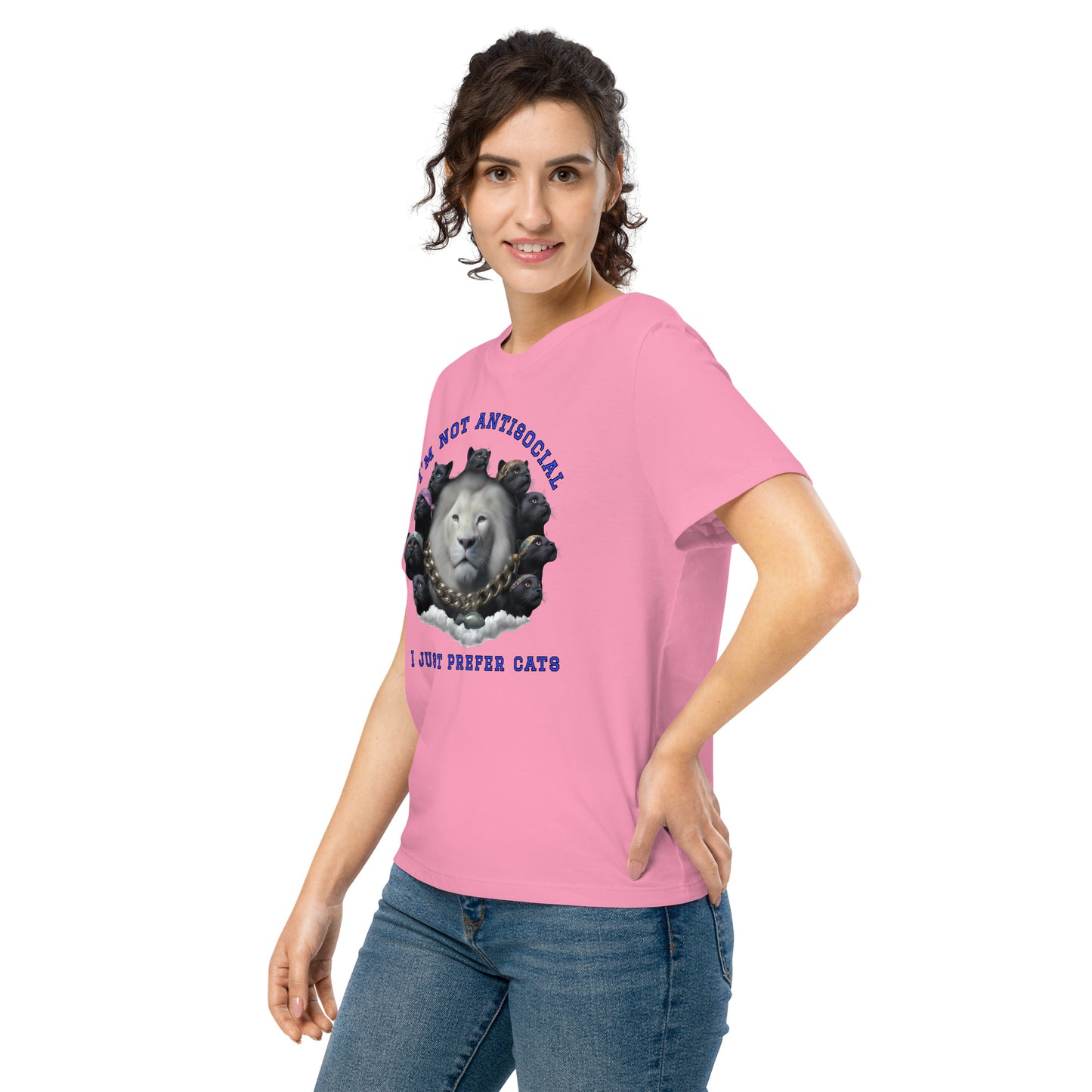 Product mockup. A woman wearing a pink organic cotton t-shirt featuring a bold graphic on the front: a large white lion's head surrounded by black panthers wearing colorful bandanas, arranged in a circle. Above the graphic is the phrase 'I'M NOT ANTISOCIAL' and below it reads 'I JUST PREFER CATS' in blue capital letters.