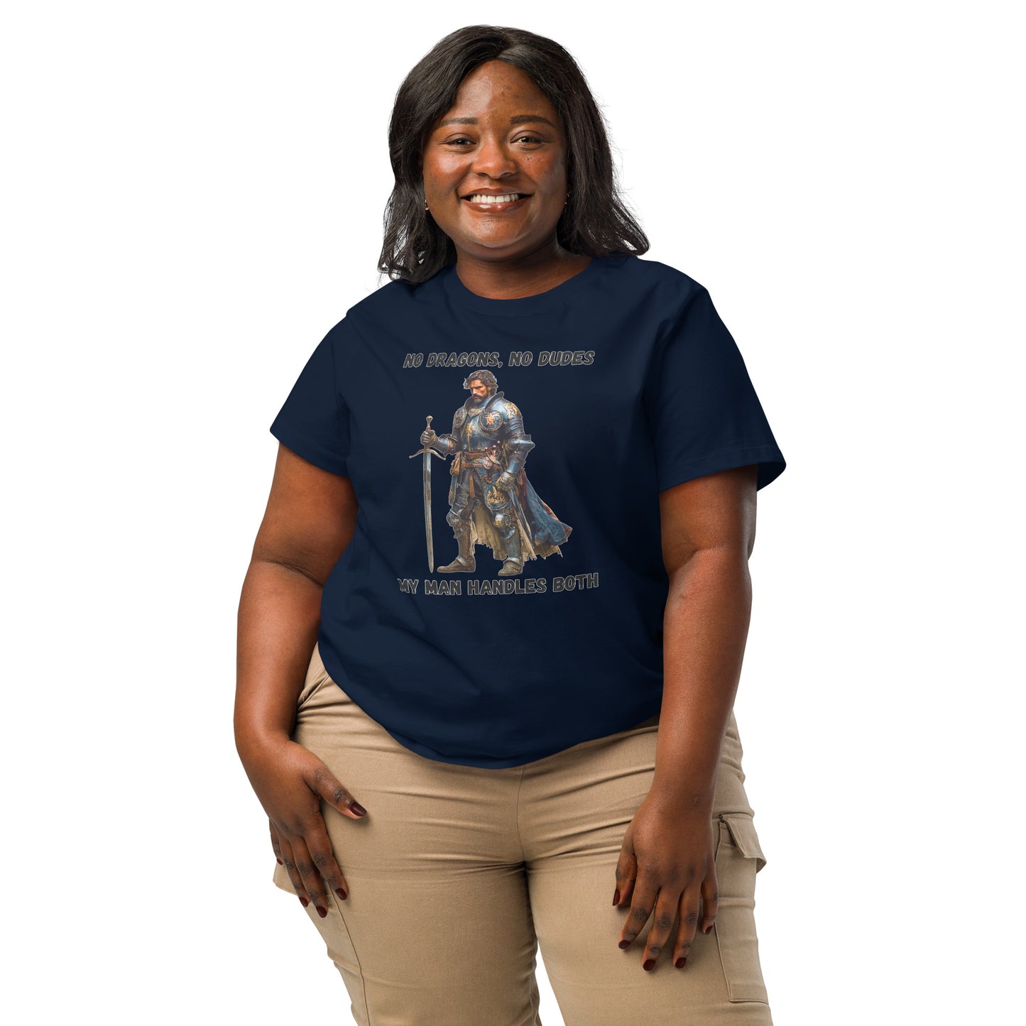 Product mockup. Organic premium navy blue t-shirt featuring warrior knight in detailed armor holding sword with bold black text above and below stating 'NO DRAGONS, NO DUDES MY MAN HANDLES BOTH,' modeled on smiling woman.