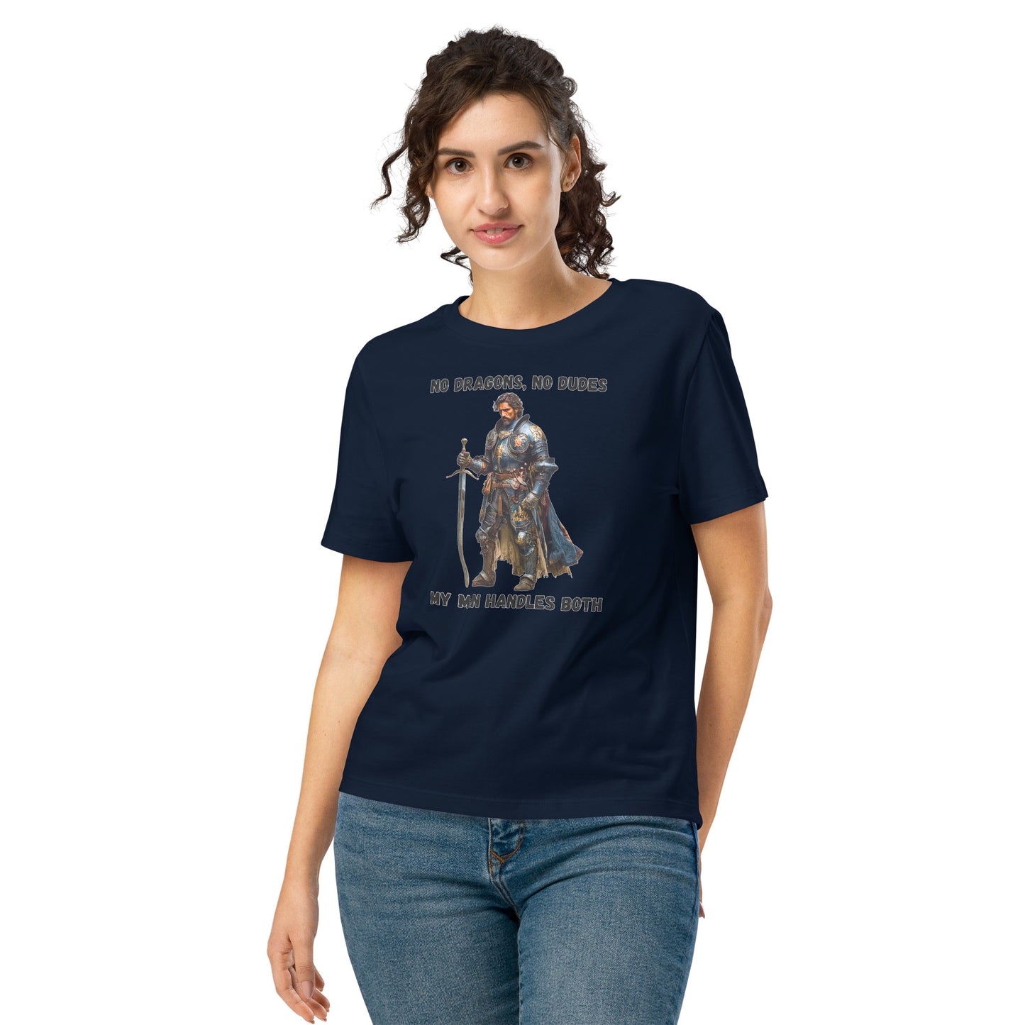 Product mockup. Organic premium navy blue t-shirt featuring warrior knight in detailed armor holding sword with bold black text above and below stating 'NO DRAGONS, NO DUDES MY MAN HANDLES BOTH,' modeled on smiling woman.