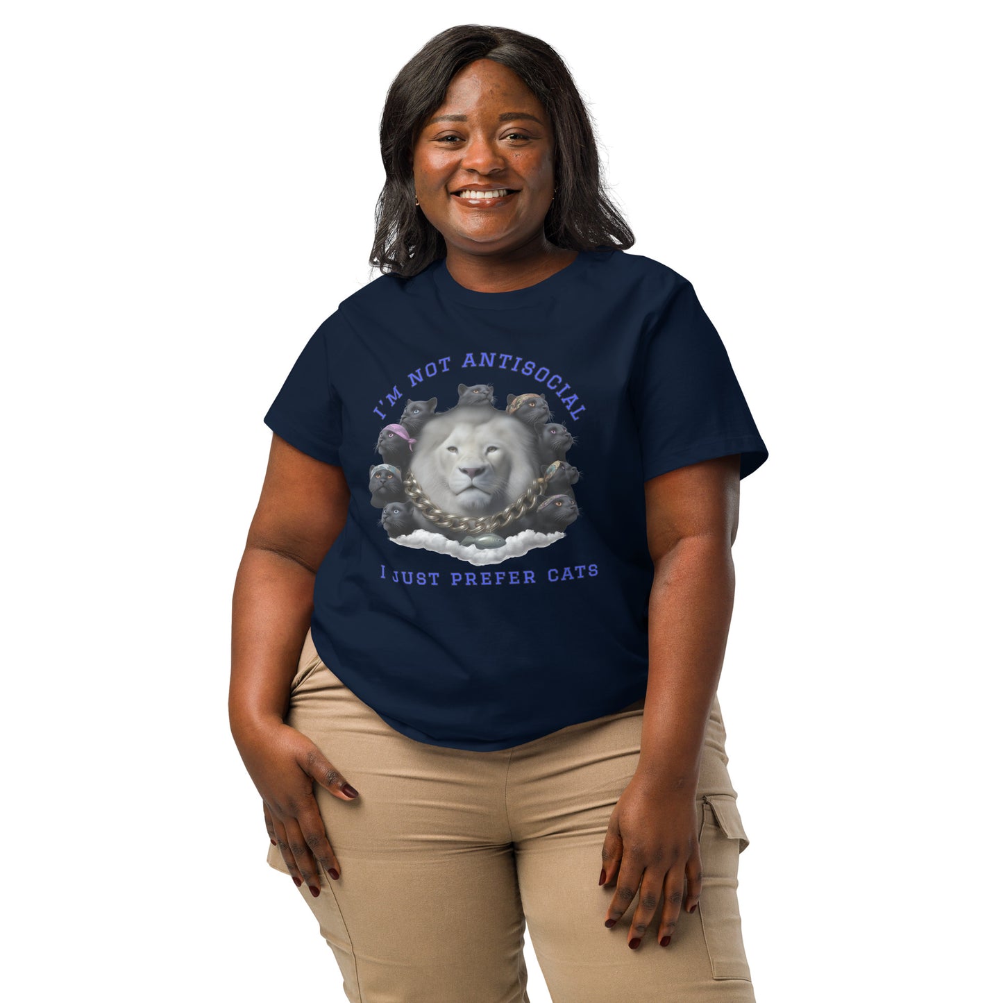 Product mockup. A woman wearing a 2XL navy blue organic cotton t-shirt featuring a bold graphic on the front: a large white lion's head surrounded by black panthers wearing colorful bandanas, arranged in a circle. Above the graphic is the phrase 'I'M NOT ANTISOCIAL' and below it reads 'I JUST PREFER CATS' in blue capital letters.