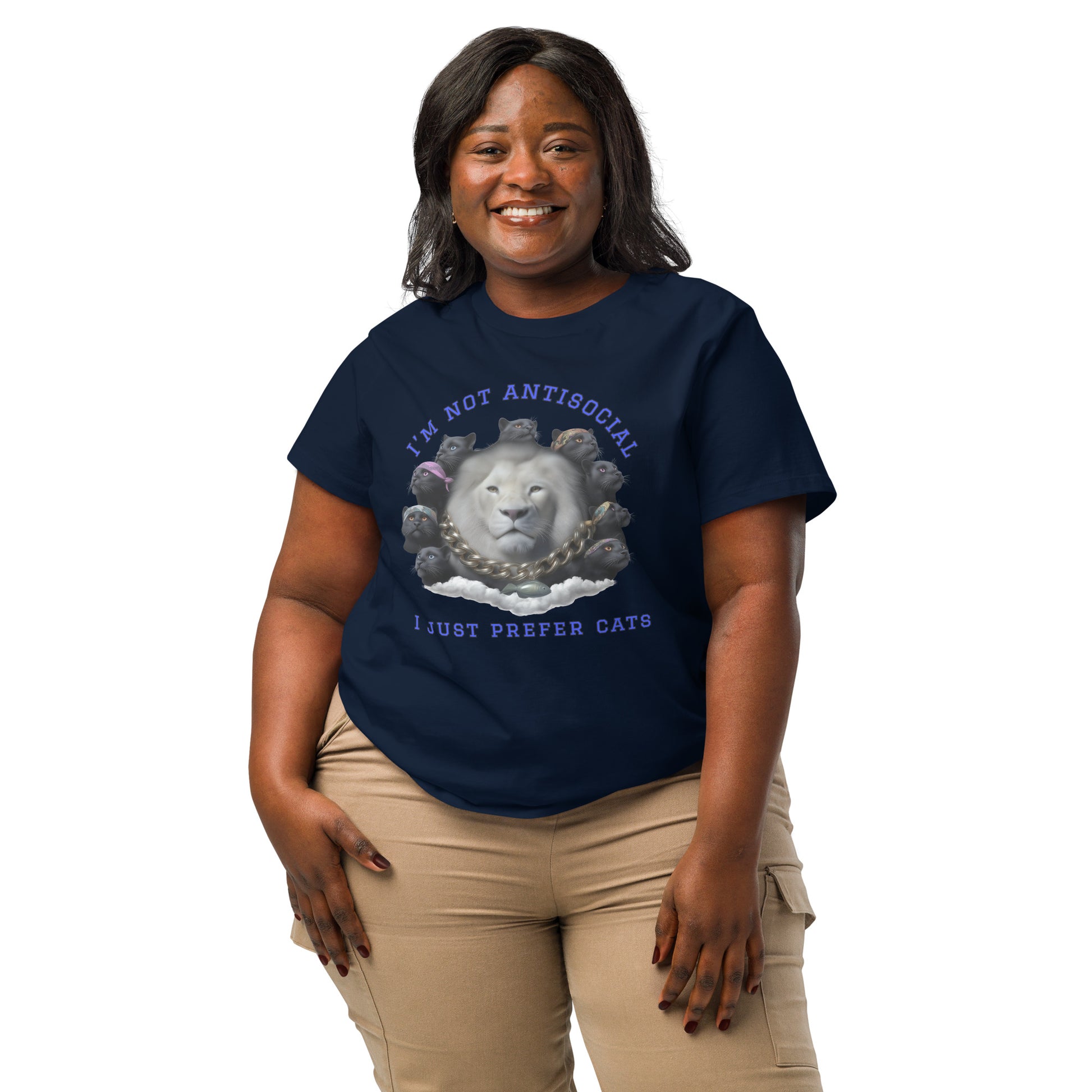Product mockup. A woman wearing a 2XL navy blue organic cotton t-shirt featuring a bold graphic on the front: a large white lion's head surrounded by black panthers wearing colorful bandanas, arranged in a circle. Above the graphic is the phrase 'I'M NOT ANTISOCIAL' and below it reads 'I JUST PREFER CATS' in blue capital letters.