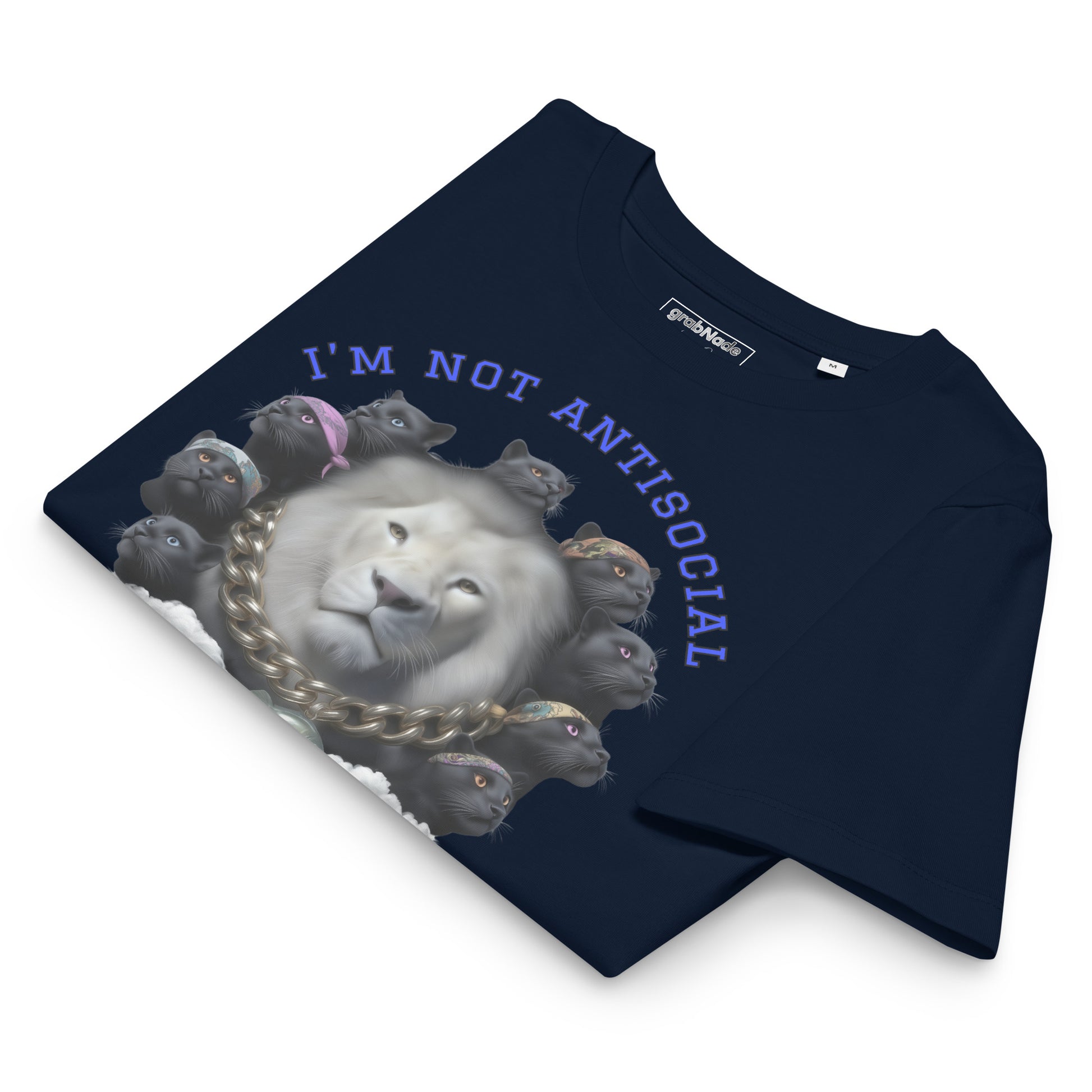 Product mockup. A folded navy blue organic cotton t-shirt with a bold graphic on the front showing a large white lion's head surrounded by a circle of black panthers wearing colorful bandanas. Above the image, arched blue text reads, 'I'M NOT ANTISOCIAL.