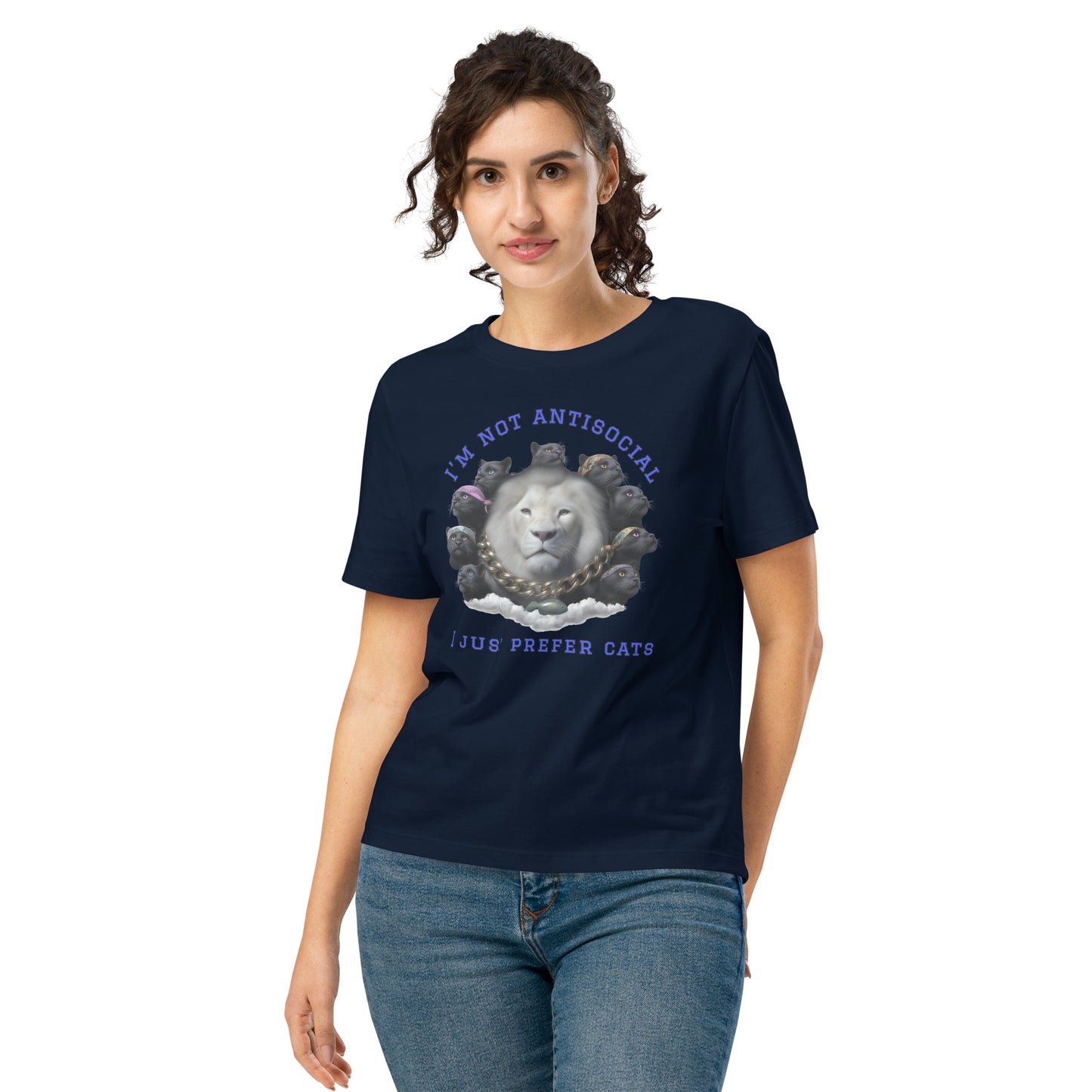 Product mockup. A woman wearing a navy blue organic cotton t-shirt featuring a bold graphic on the front: a large white lion's head surrounded by black panthers wearing colorful bandanas, arranged in a circle. Above the graphic is the phrase 'I'M NOT ANTISOCIAL' and below it reads 'I JUST PREFER CATS' in blue capital letters.