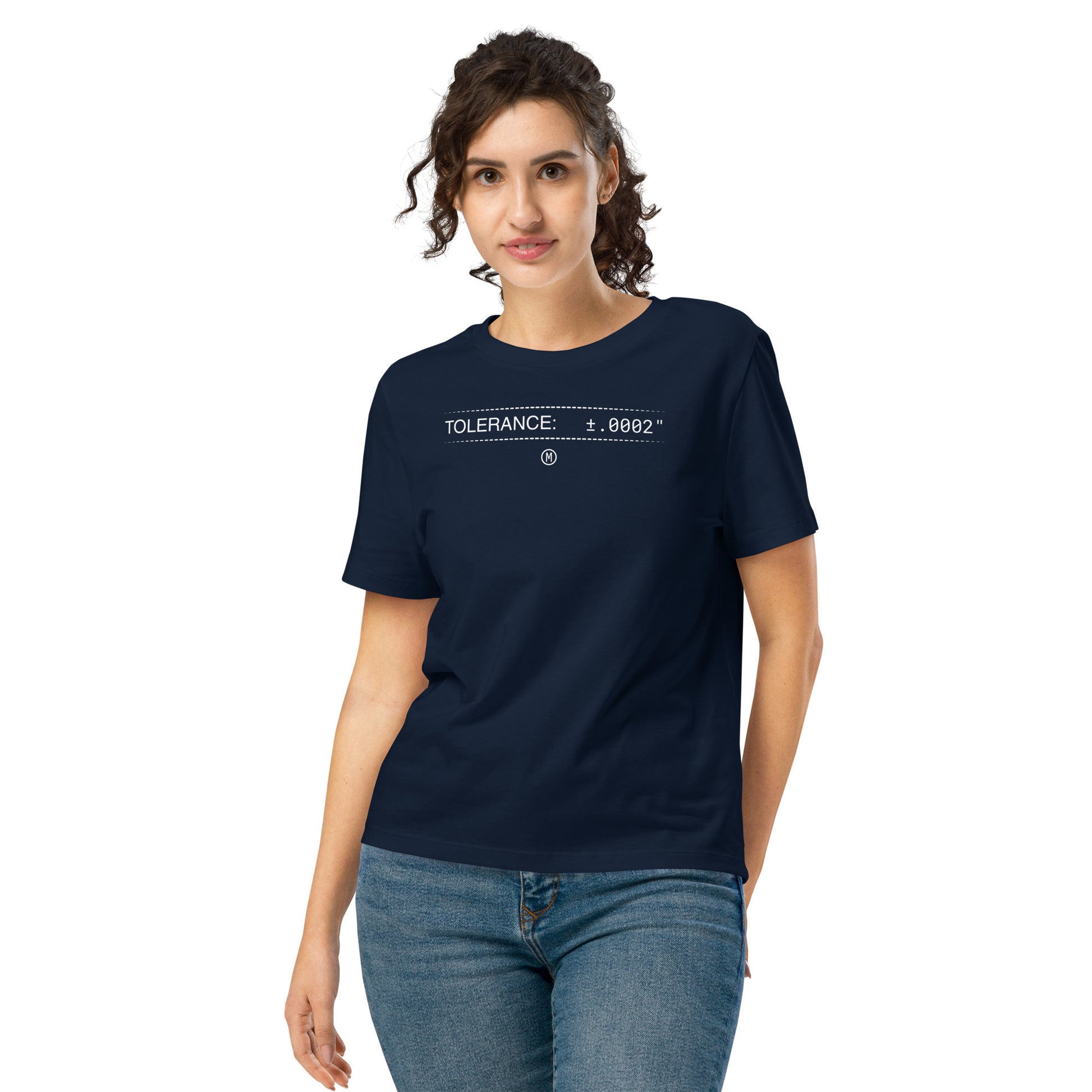 Woman in organic navy premium t-shirt with white text "TOLERANCE: ±.0002" for mechanical engineers.