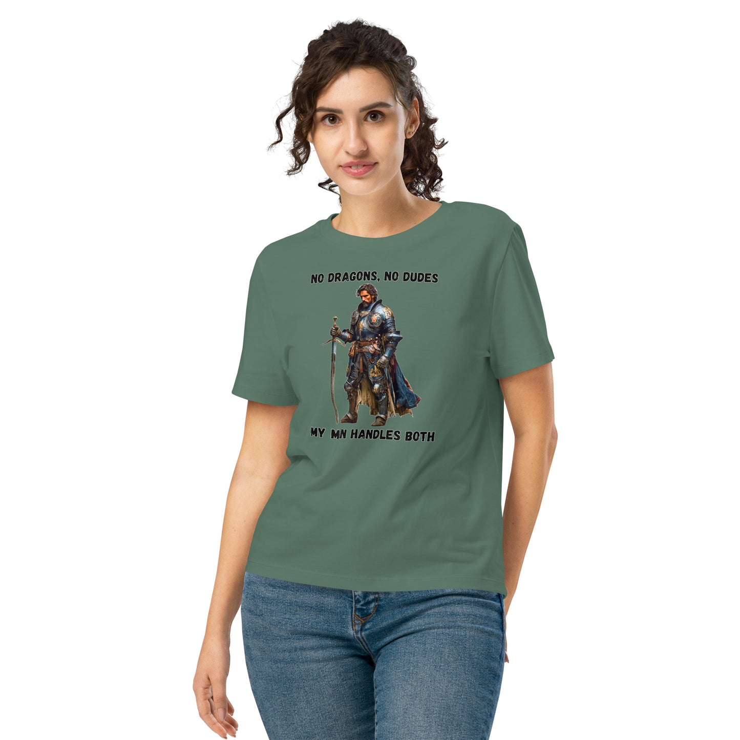 Product mockup. Organic premium green t-shirt featuring warrior knight in detailed armor holding sword with bold black text above and below stating 'NO DRAGONS, NO DUDES MY MAN HANDLES BOTH,' modeled on smiling woman.