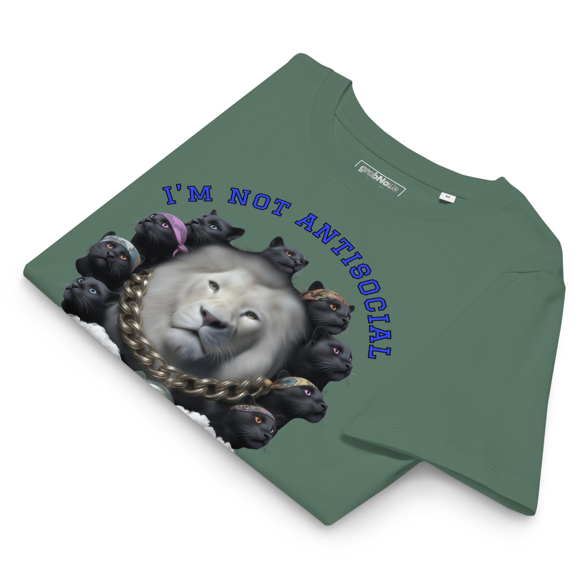 Product mockup. A folded green organic cotton t-shirt with a bold graphic on the front showing a large white lion's head surrounded by a circle of black panthers wearing colorful bandanas. Above the image, arched blue text reads, 'I'M NOT ANTISOCIAL.