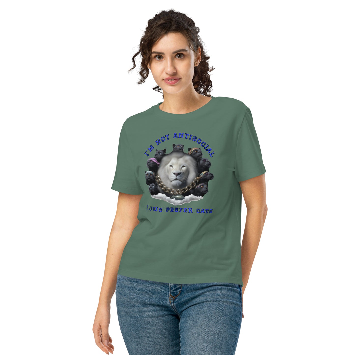 Product mockup. A woman wearing a green organic cotton t-shirt featuring a bold graphic on the front: a large white lion's head surrounded by black panthers wearing colorful bandanas, arranged in a circle. Above the graphic is the phrase 'I'M NOT ANTISOCIAL' and below it reads 'I JUST PREFER CATS' in blue capital letters.