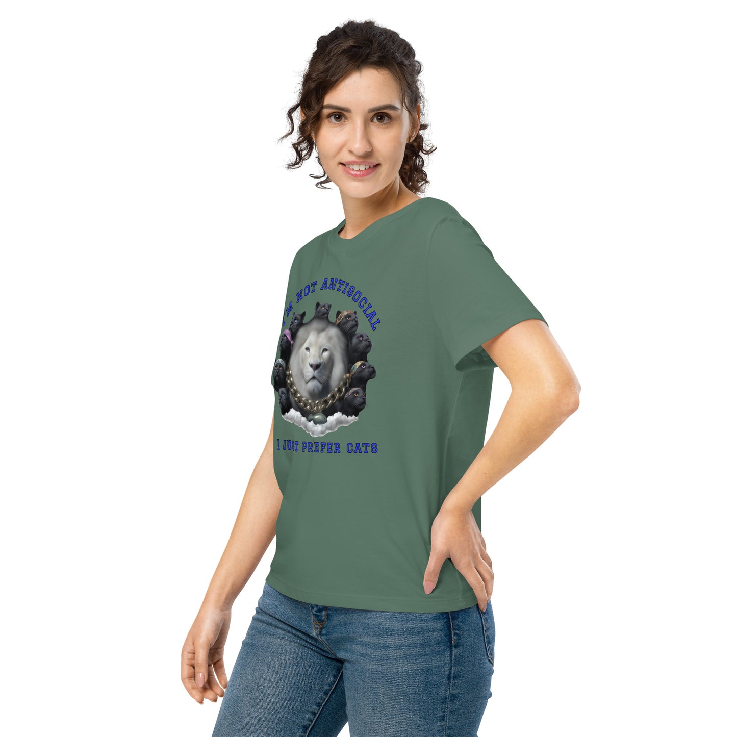 Product mockup. A woman wearing a green organic cotton t-shirt featuring a bold graphic on the front: a large white lion's head surrounded by black panthers wearing colorful bandanas, arranged in a circle. Above the graphic is the phrase 'I'M NOT ANTISOCIAL' and below it reads 'I JUST PREFER CATS' in blue capital letters.