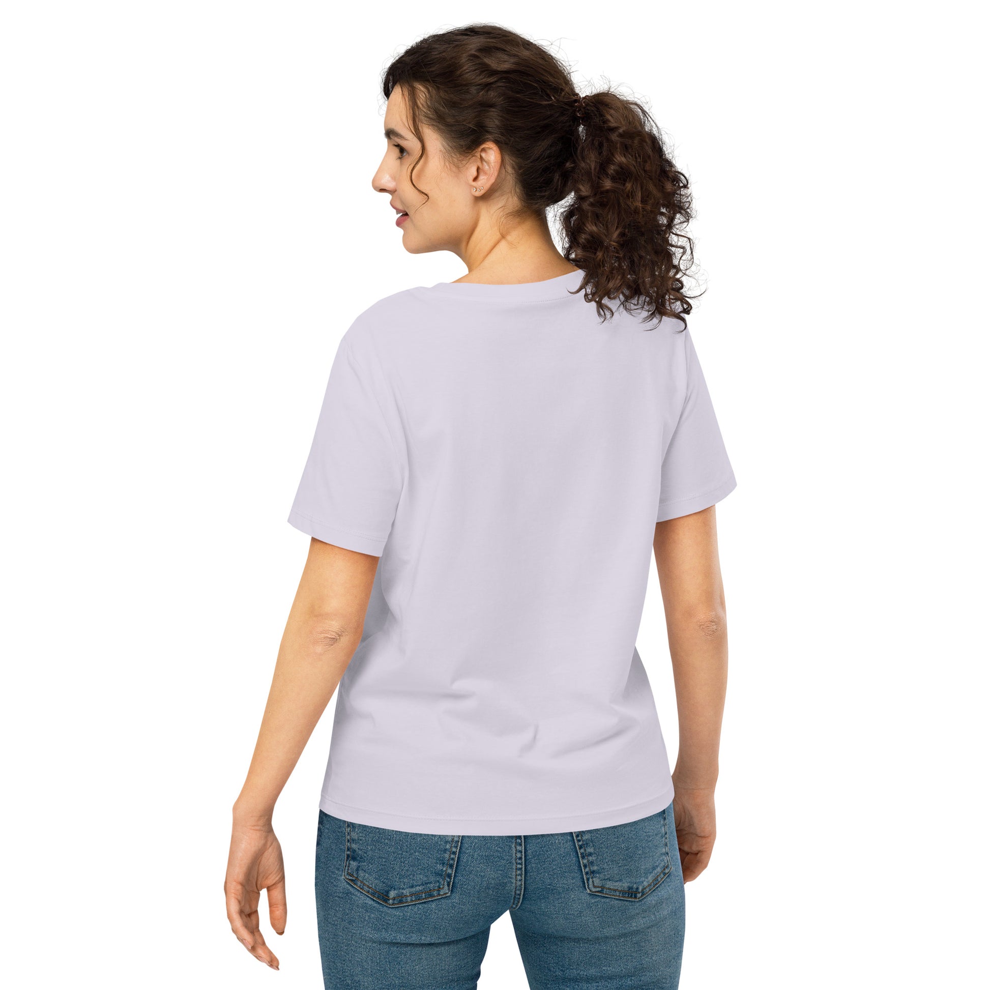 Product mockup. A woman shown from behind wearing a plain lavender organic cotton t-shirt with short sleeves. The shirt has a relaxed fit, and no design or graphics appear on the back. She is also wearing blue jeans pants.
