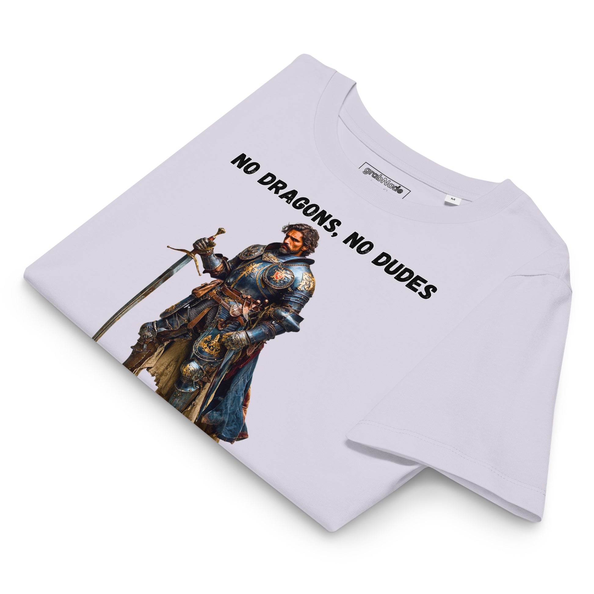 Product mockup. Folded organic premium lavender t-shirt featuring warrior knight in detailed armor holding sword with bold black text above and below stating 'NO DRAGONS, NO DUDES'.