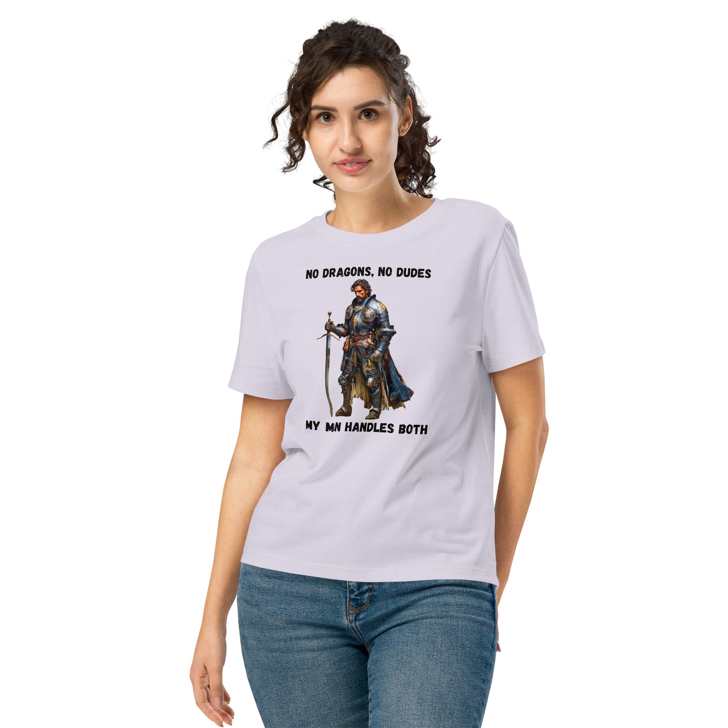 Product mockup. Organic premium lavender t-shirt featuring warrior knight in detailed armor holding sword with bold black text above and below stating 'NO DRAGONS, NO DUDES MY MAN HANDLES BOTH,' modeled on smiling woman.