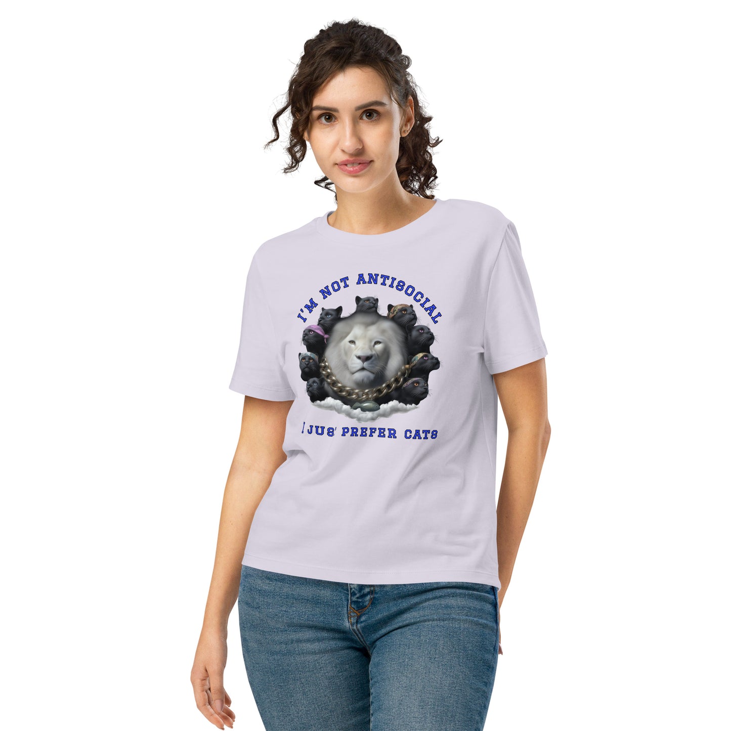 Product mockup. A woman wearing a lavender organic cotton t-shirt featuring a bold graphic on the front: a large white lion's head surrounded by black panthers wearing colorful bandanas, arranged in a circle. Above the graphic is the phrase 'I'M NOT ANTISOCIAL' and below it reads 'I JUST PREFER CATS' in blue capital letters.