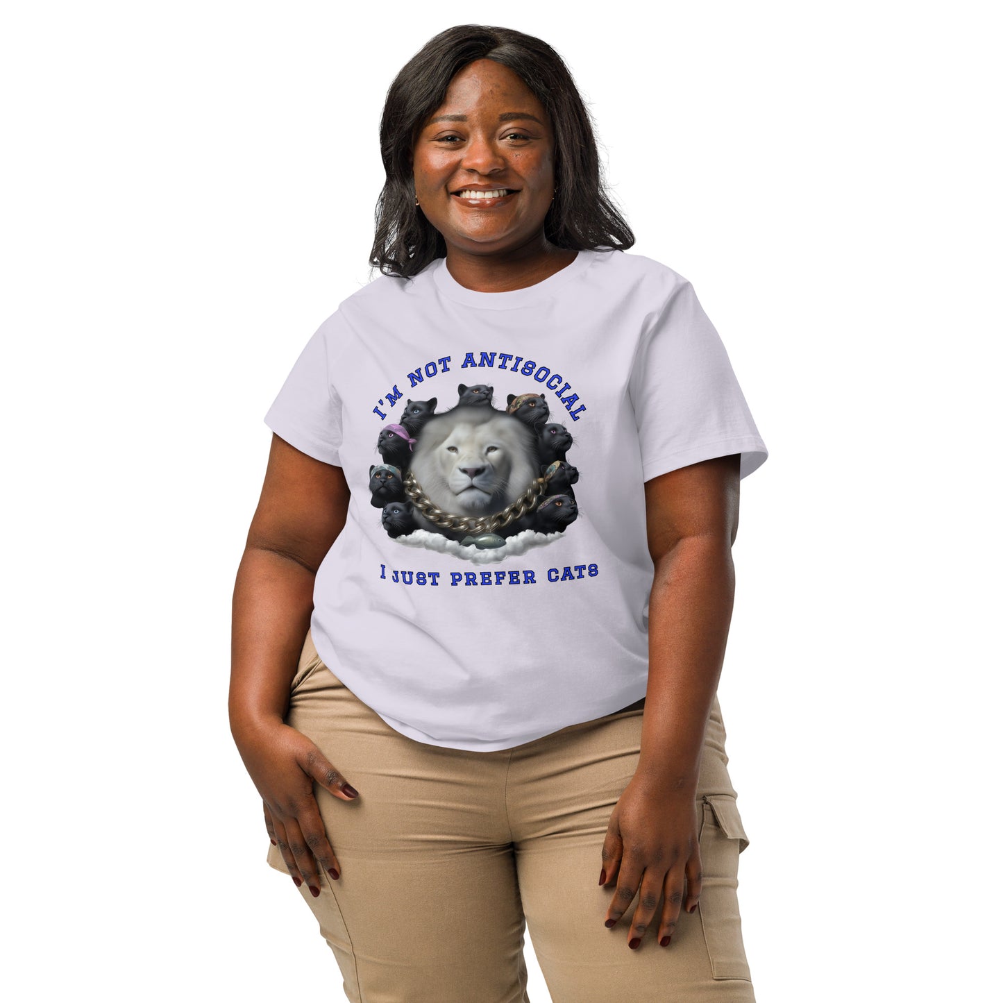 Product mockup. A woman wearing a 2XL lavender organic cotton t-shirt featuring a bold graphic on the front: a large white lion's head surrounded by black panthers wearing colorful bandanas, arranged in a circle. Above the graphic is the phrase 'I'M NOT ANTISOCIAL' and below it reads 'I JUST PREFER CATS' in blue capital letters.