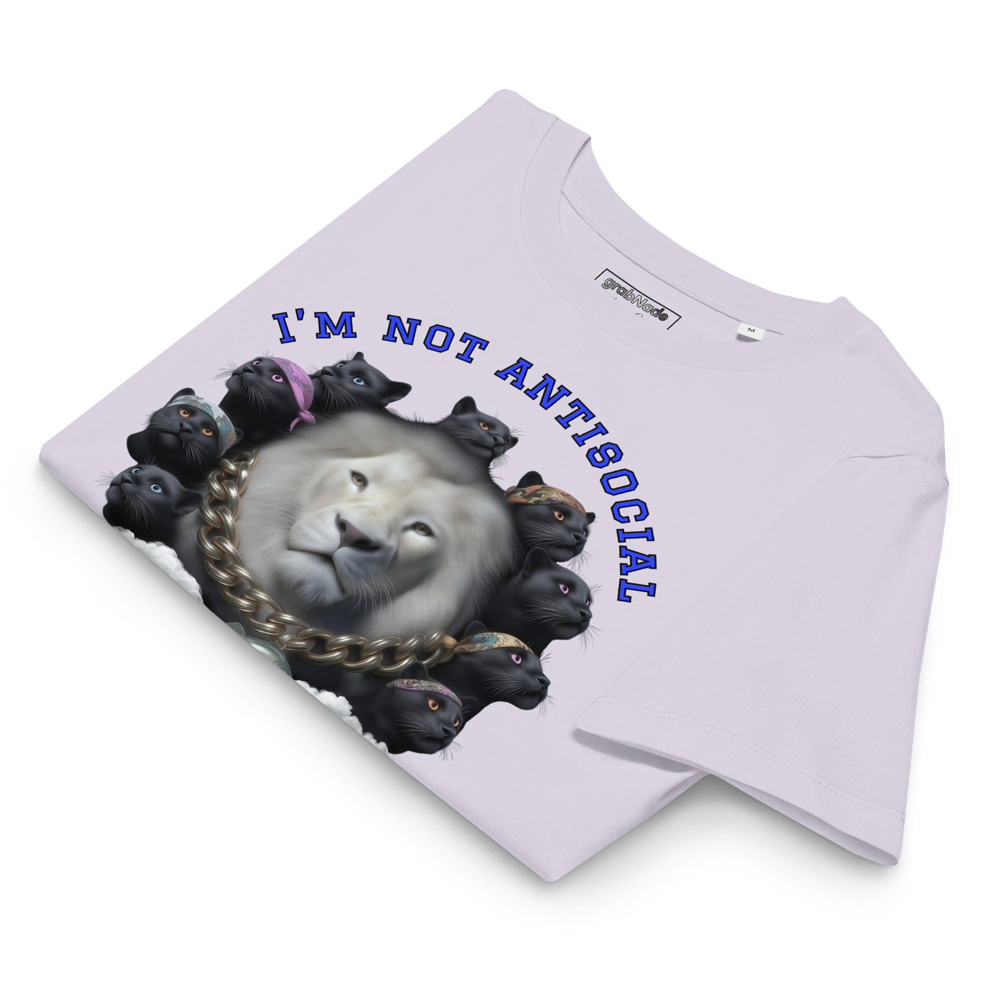 Product mockup. A folded lavender organic cotton t-shirt with a bold graphic on the front showing a large white lion's head surrounded by a circle of black panthers wearing colorful bandanas. Above the image, arched blue text reads, 'I'M NOT ANTISOCIAL.
