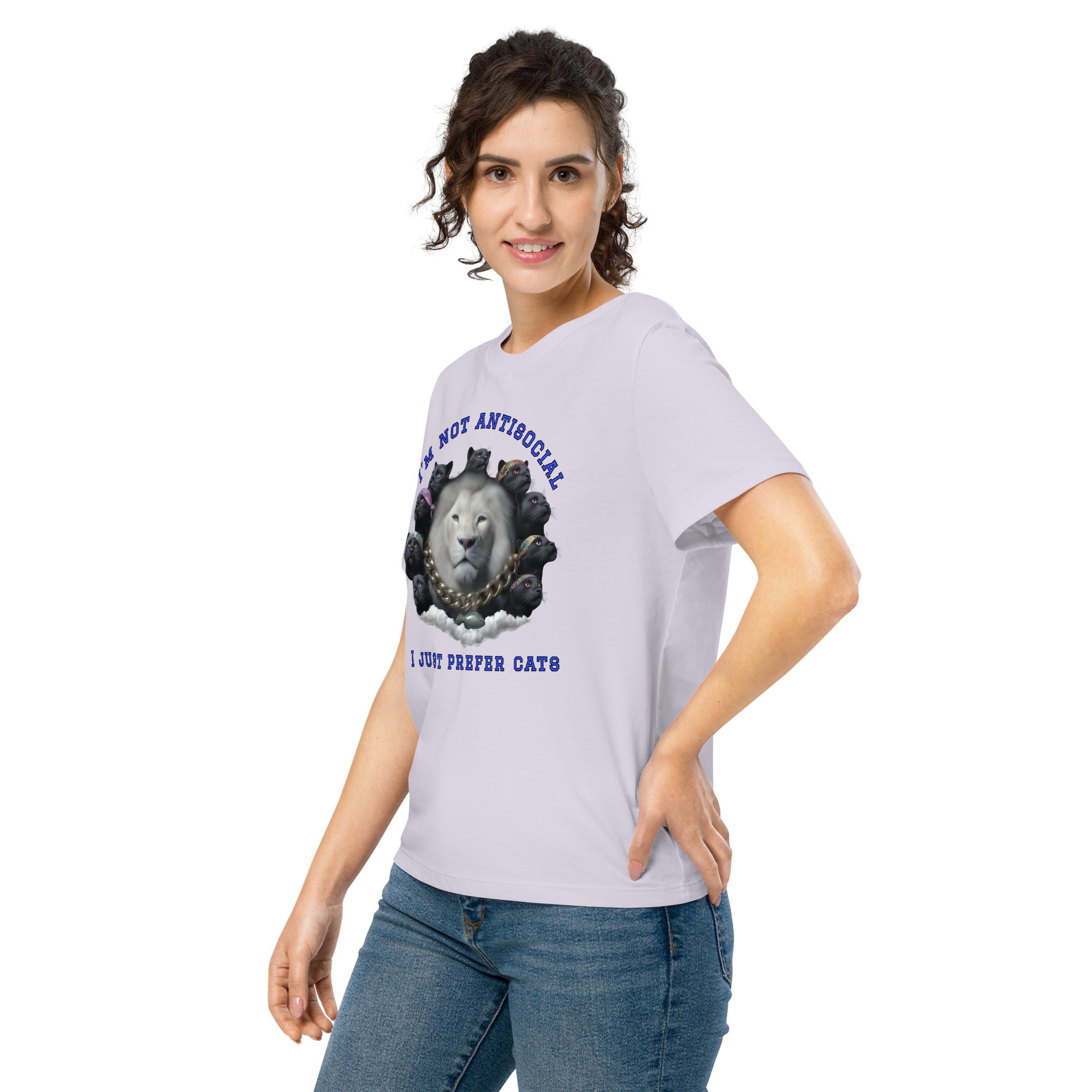 Product mockup. A woman wearing a lavender organic cotton t-shirt featuring a bold graphic on the front: a large white lion's head surrounded by black panthers wearing colorful bandanas, arranged in a circle. Above the graphic is the phrase 'I'M NOT ANTISOCIAL' and below it reads 'I JUST PREFER CATS' in blue capital letters.