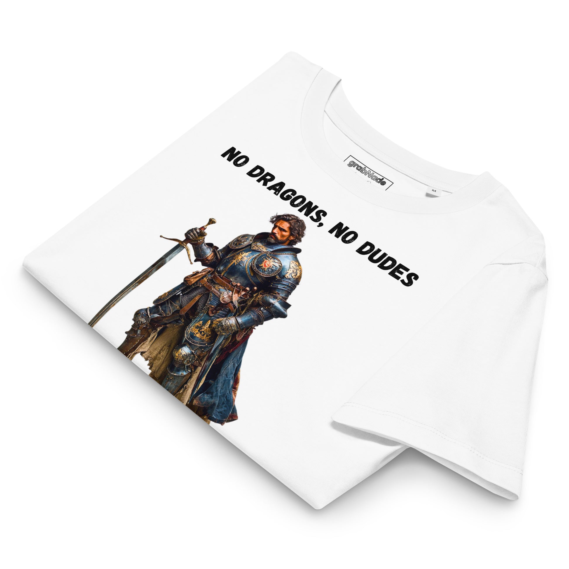 Product mockup. Folded organic premium white t-shirt featuring warrior knight in detailed armor holding sword with bold black text above and below stating 'NO DRAGONS, NO DUDES'.