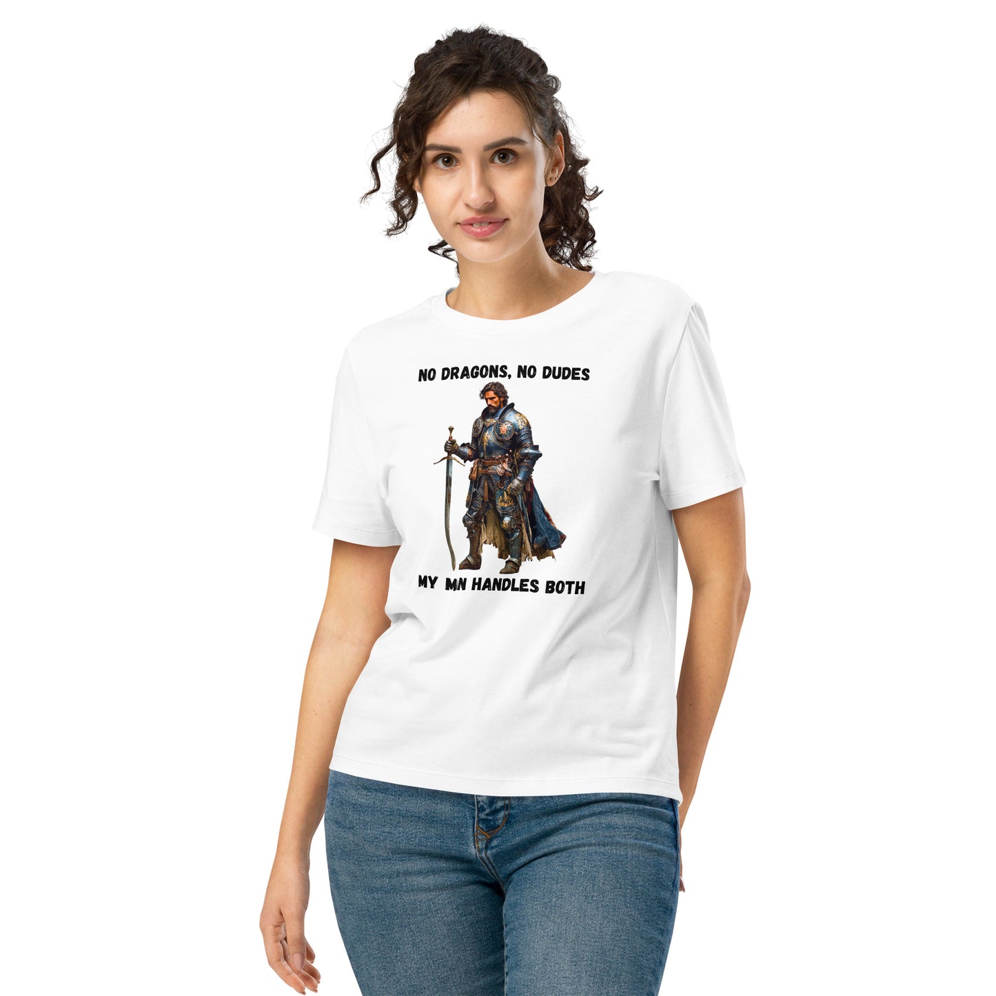 Product mockup. Organic premium white t-shirt featuring warrior knight in detailed armor holding sword with bold black text above and below stating 'NO DRAGONS, NO DUDES MY MAN HANDLES BOTH,' modeled on smiling woman.
