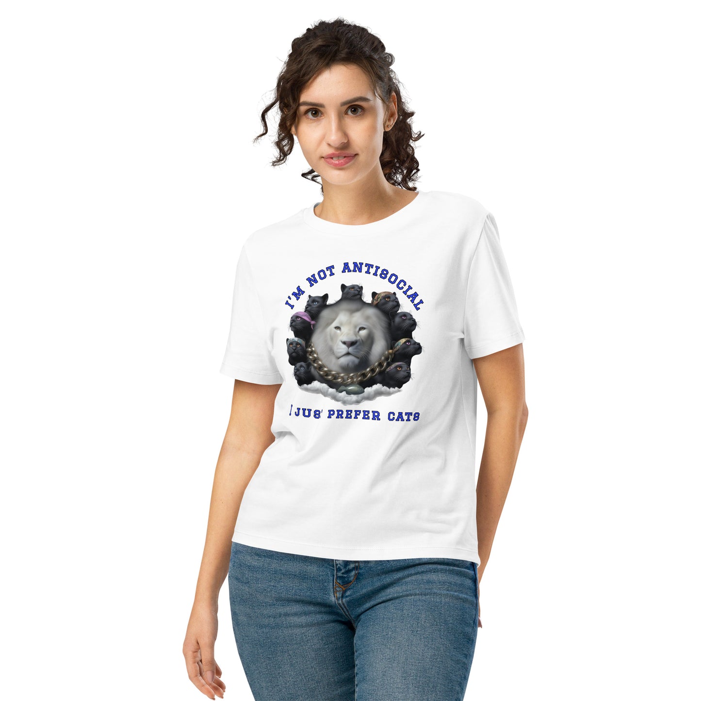 Product mockup. A woman wearing a white organic cotton t-shirt featuring a bold graphic on the front: a large white lion's head surrounded by black panthers wearing colorful bandanas, arranged in a circle. Above the graphic is the phrase 'I'M NOT ANTISOCIAL' and below it reads 'I JUST PREFER CATS' in blue capital letters.