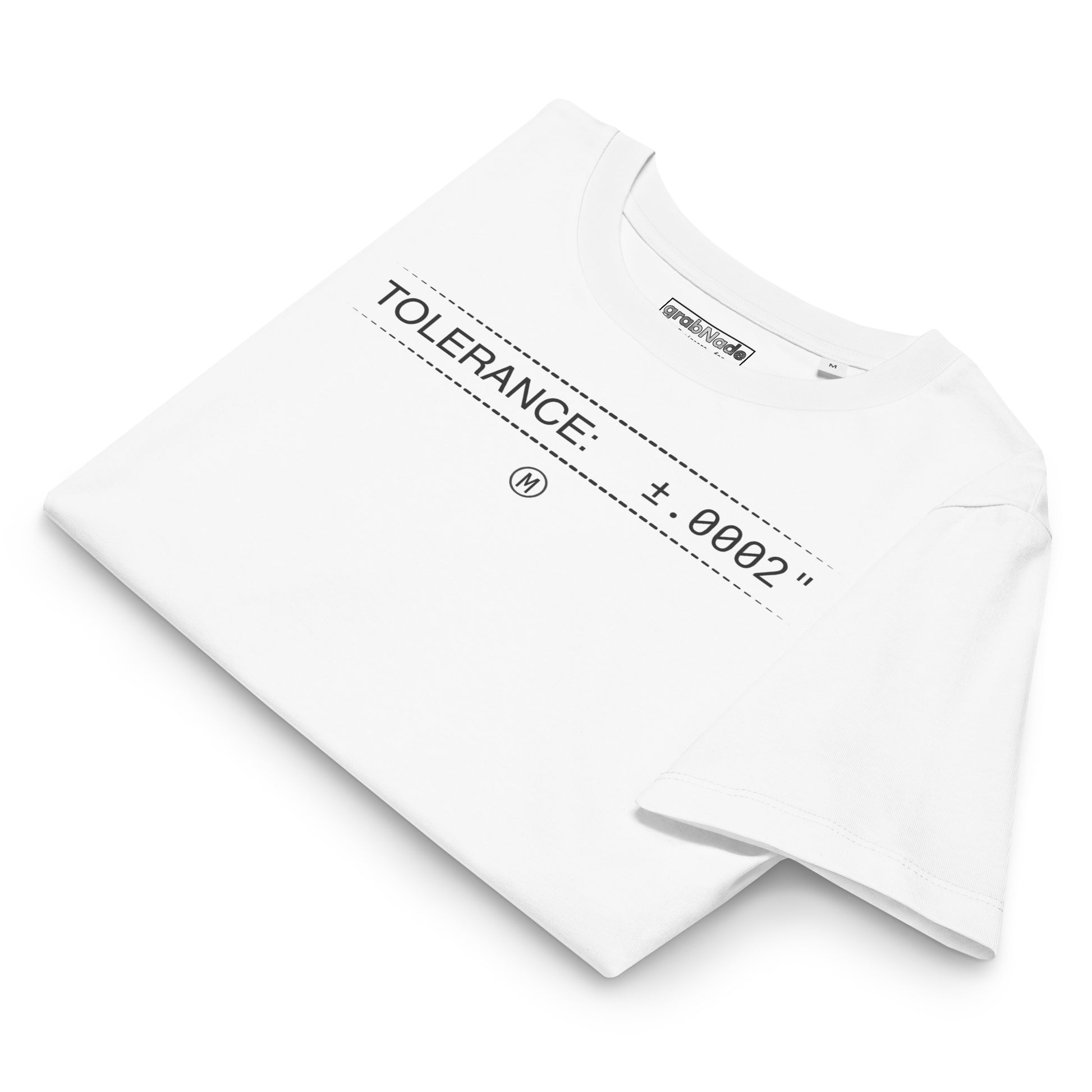 Folded organic white premium t-shirt with text "TOLERANCE: ±.0002" for mechanical engineers.