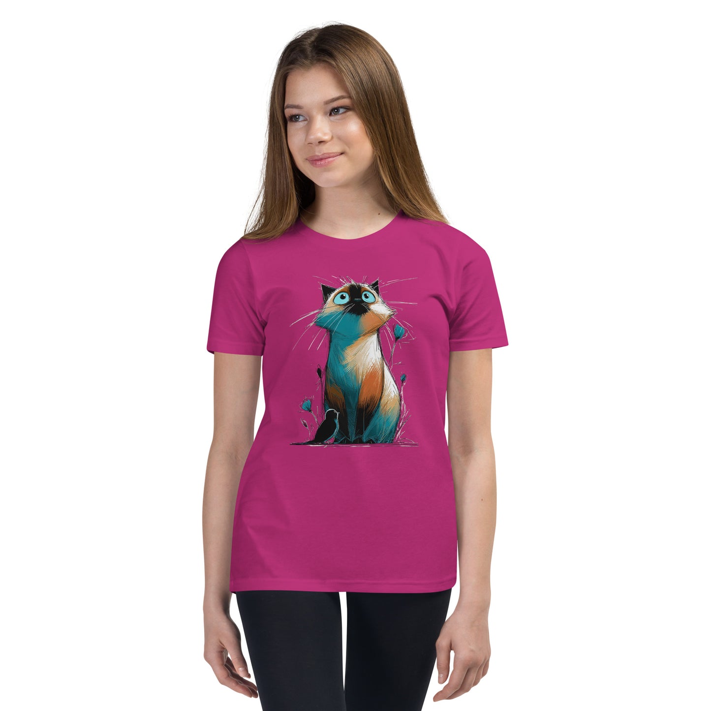 Product mockup. Ultra-soft premium youth pink t-shirt featuring colorful artistic drawing of a wide-eyed cat sitting beside flowers and a black bird, modeled on young girl.