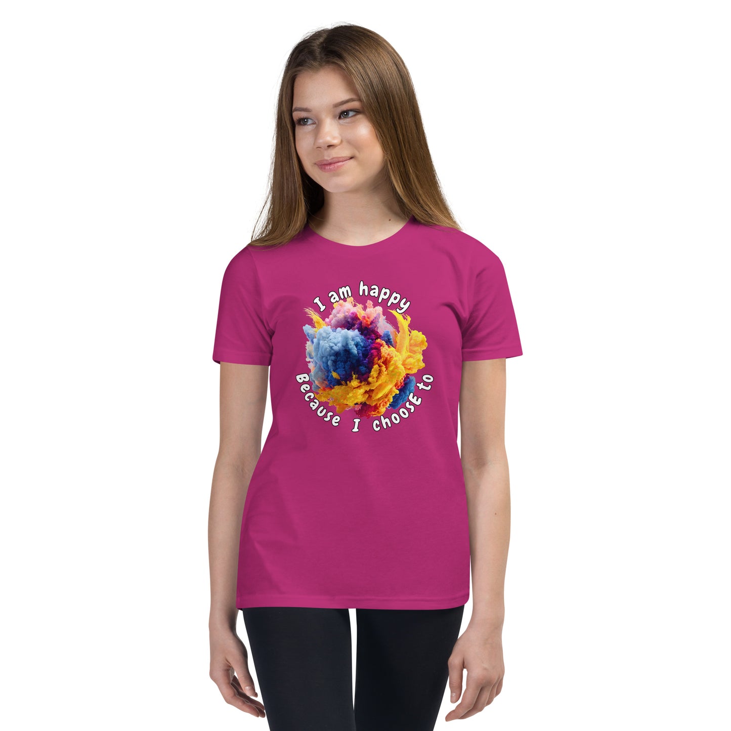 Product mockup. Ultra-soft premium pink t-shirt featuring vibrant multicolor abstract explosion graphic with text 'I am happy Because I choose to' printed in curved style around the design, modeled on young woman.
