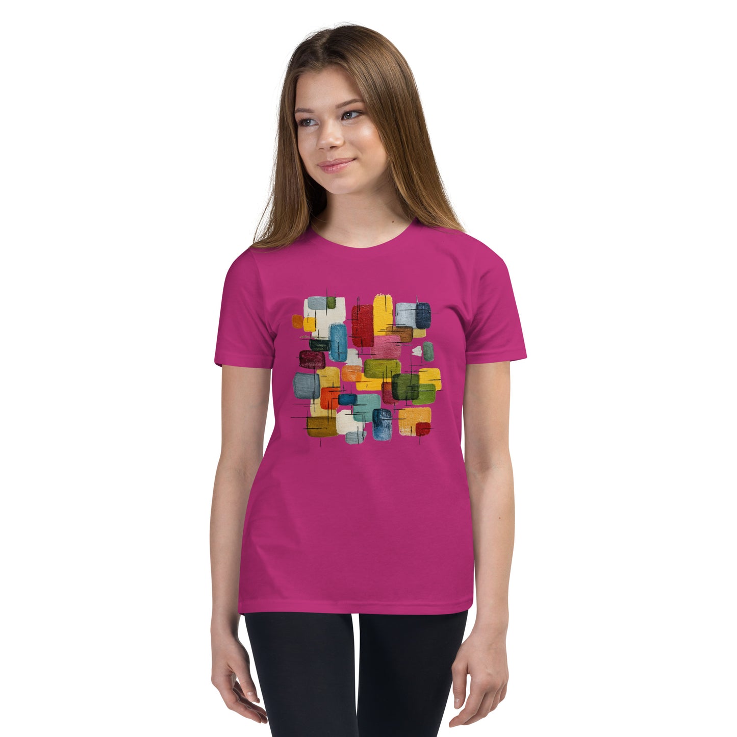 Product mockup. A young woman wearing a pink, short-sleeve t-shirt with a large, colorful abstract design on the front. The design features overlapping rounded rectangles in red, yellow, teal, blue, green, and orange, with fine black sketch lines, creating a playful and modern look. She is also wearing black leggings.