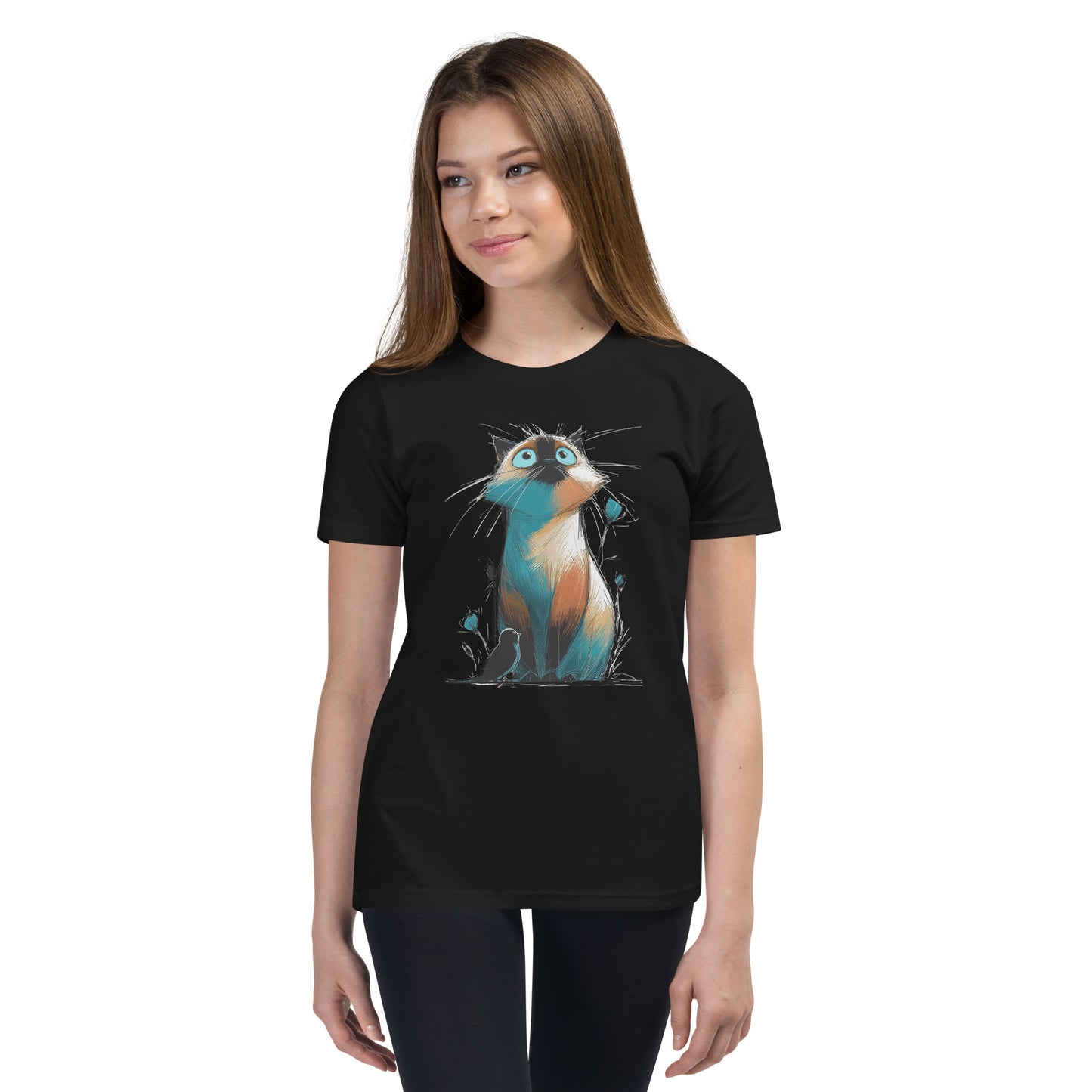 Product mockup. Ultra-soft premium youth black t-shirt featuring colorful artistic drawing of a wide-eyed cat sitting beside flowers and a black bird, modeled on young girl.