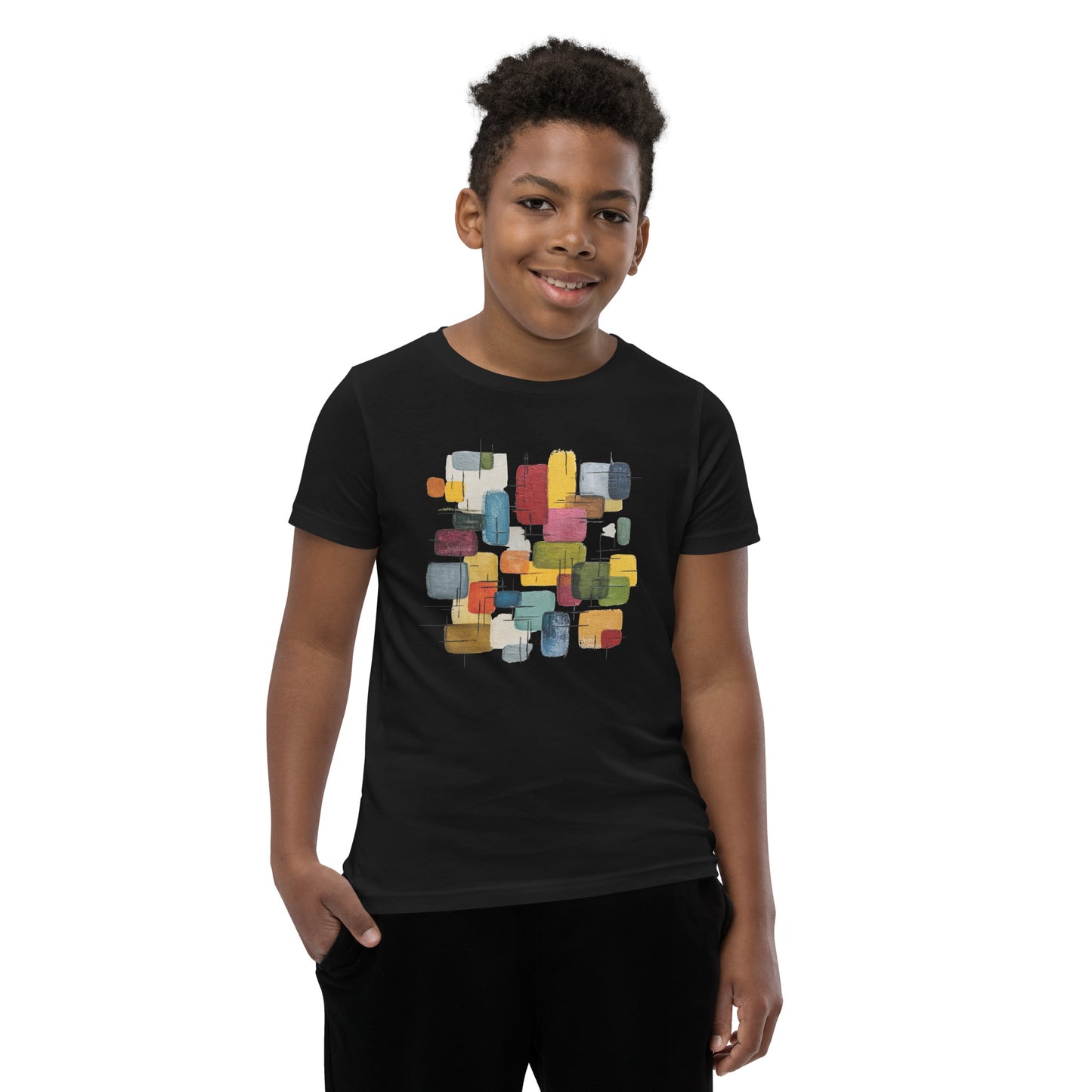 Product mockup. A young man wearing a black, short-sleeve t-shirt with a large, colorful abstract design on the front. The design features overlapping rounded rectangles in red, yellow, teal, blue, green, and orange, with fine black sketch lines, creating a playful and modern look. She is also wearing black leggings.